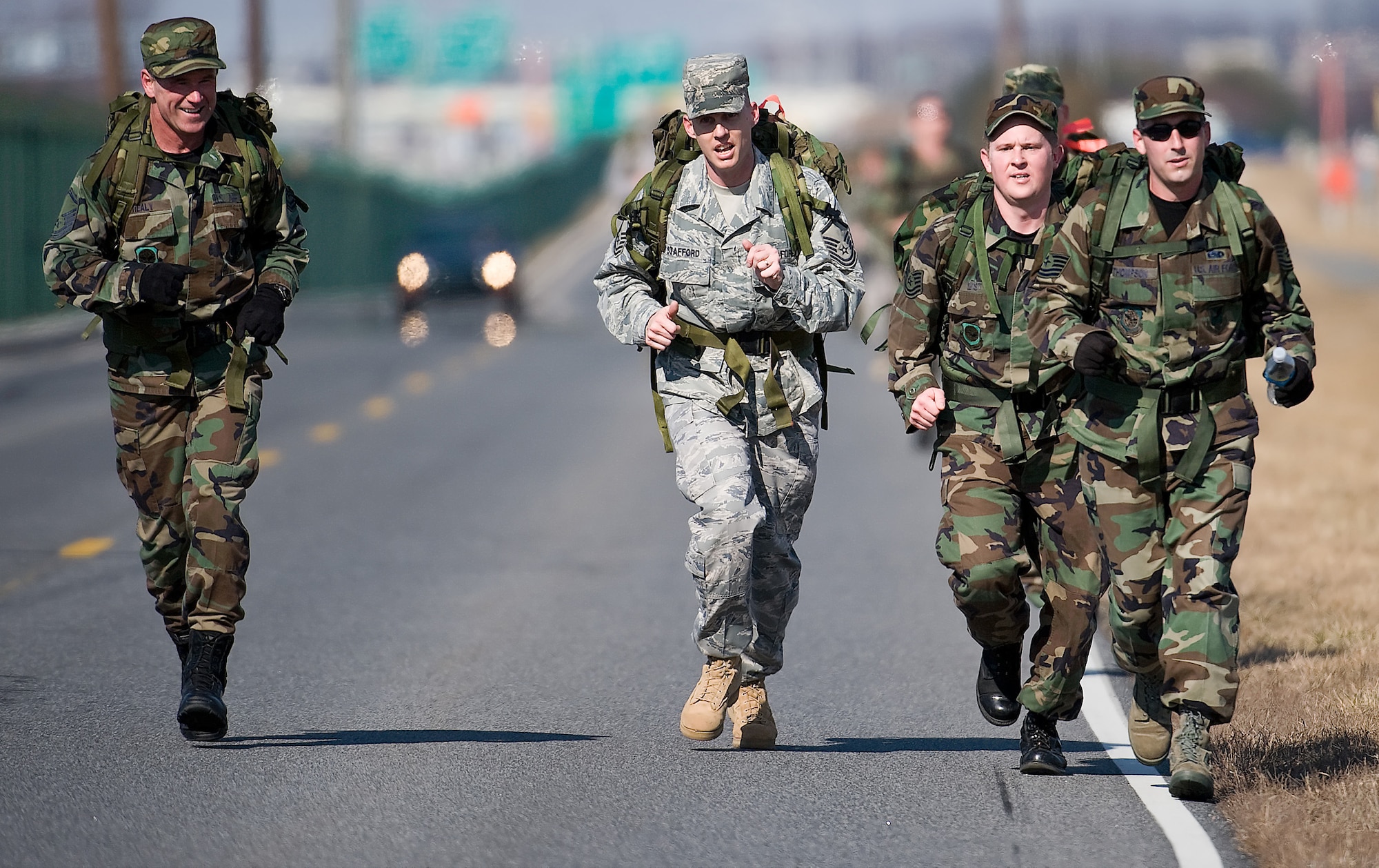 (Left to right) Master Sgt. (ret.) John Healy, Master Sgt. Marshall Stafford, 436th Aerial Port Squadron, Tech. Sgt. Jason Gist, 436th Communications Squadron, and Tech. Sgt. Christopher Thompson, 436th CS, make their trek on Perimeter Road towards the finish line for the 10th Annual Ruck March Feb. 21 at the Air Mobility Command Museum. (U.S. Air Force photo/ Roland Balik)