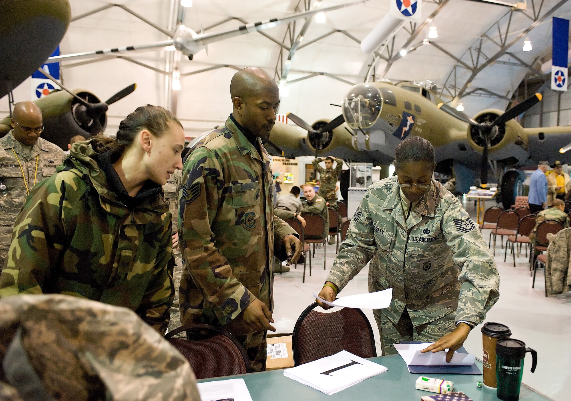 Tech. Sgt. Pamela Mosley, 436th Security Forces Squadron, hands out paperwork to participants in Dover?s 10th annual Ruck March Feb. 21 at the Air Mobility Command Museum. (U.S. Air Force photo/ Roland Balik)
