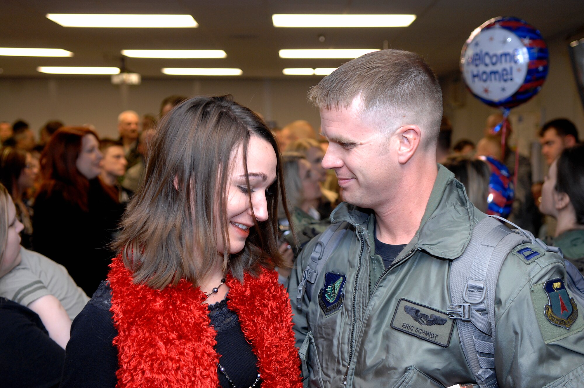 MINOT AIR FORCE BASE, N.D. -- Laura Schmidt, wife of Capt. Eric Schmidt, 23rd Bomb Squadron pilot, embraces her husband upon his return here Feb. 23 from Andersen AFB, Guam. The 5th Bomb Wing sent six B-52H Stratofortresses and more than 200 personnel to provide a continuous bomber presence in U.S. Pacific Air Command. (U.S. Air Force photo by Airman 1st Class Benjamin Stratton)