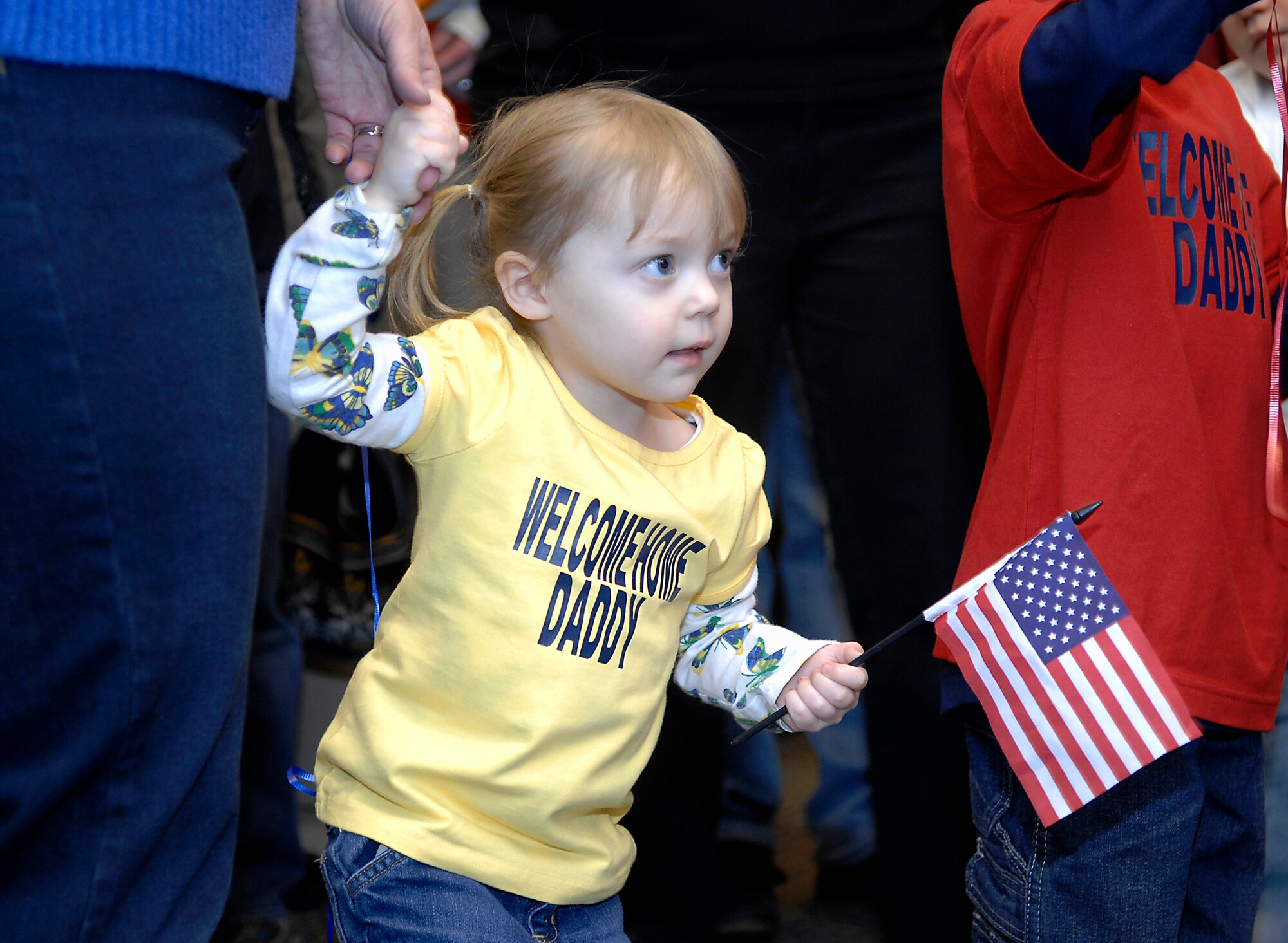 MINOT AIR FORCE BASE, N.D. -- Sylvia Cowper, daughter of Master Sgt. Frank Cowper, 5th Aircraft Maintenance Squadron production manager, waves an American flag as she awaits the return of her, “daddy” here Feb. 23 from Andersen AFB, Guam. The 5th Bomb Wing sent six B-52H Stratofortresses and more than 200 personnel to provide a continuous bomber presence in U.S. Pacific Air Command. 2009 was a year that brought progress and a renewed emphasis on safe, secure and reliable nuclear operations. The 91st Missile Wing transitioned to Air Force Global Strike Command with the 5th Bomb Wing scheduled to follow suit in 2010. (U.S. Air Force photo by Airman 1st Class Benjamin Stratton)