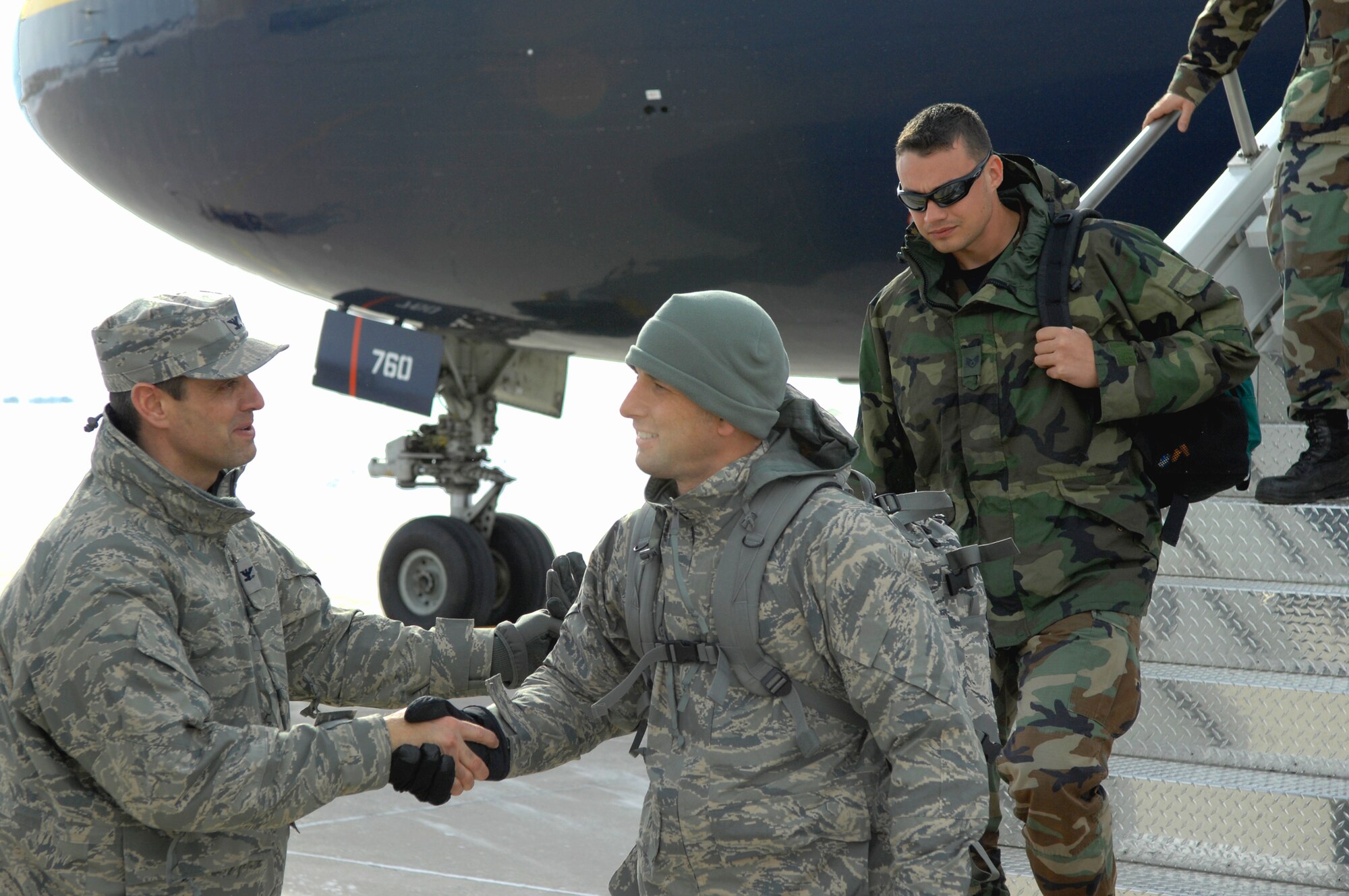 MINOT AIR FORCE BASE, N.D. -- Col. Steven Basham, 5th Bomb Wing vice commander, greets fellow Warbirds upon their return here Feb. 23 from Andersen AFB, Guam. The 5th BW sent six B-52H Stratofortresses and more than 200 personnel to provide a continuous bomber presence in U.S. Pacific Air Command. (U.S. Air Force photo by Airman 1st Class Benjamin Stratton)