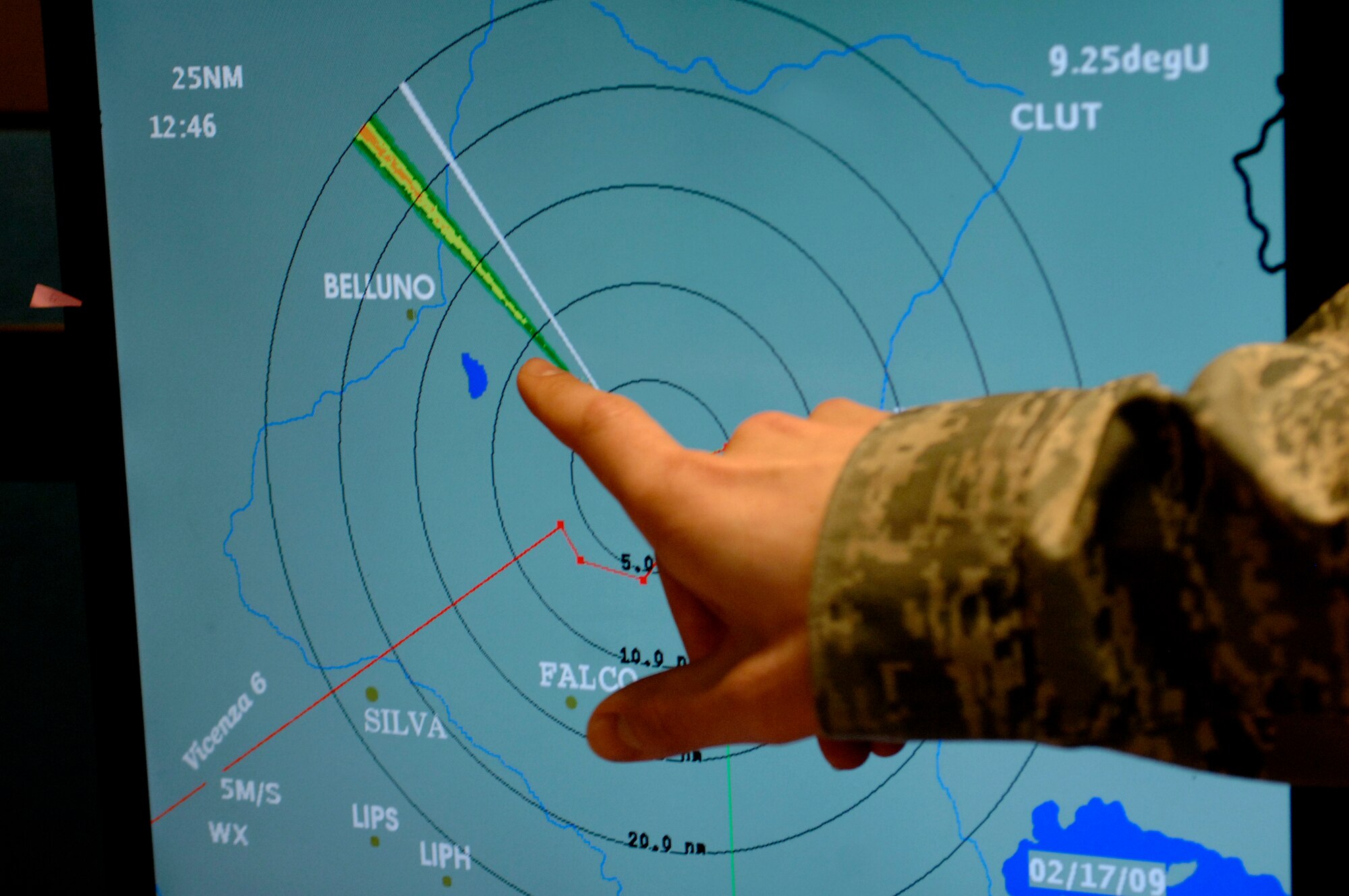 Staff Sgt. John Lacroix, a 31st Operations Support Squadron weather forecaster, trains a junior forecaster Feb. 17 on how to read satellite images that show current weather conditions around Aviano Air Base, Italy.  The satellite image shows the distance from base to the current weather condition outside.  (U.S. Air Force photo/Airman 1st Class Ashley Wood)
