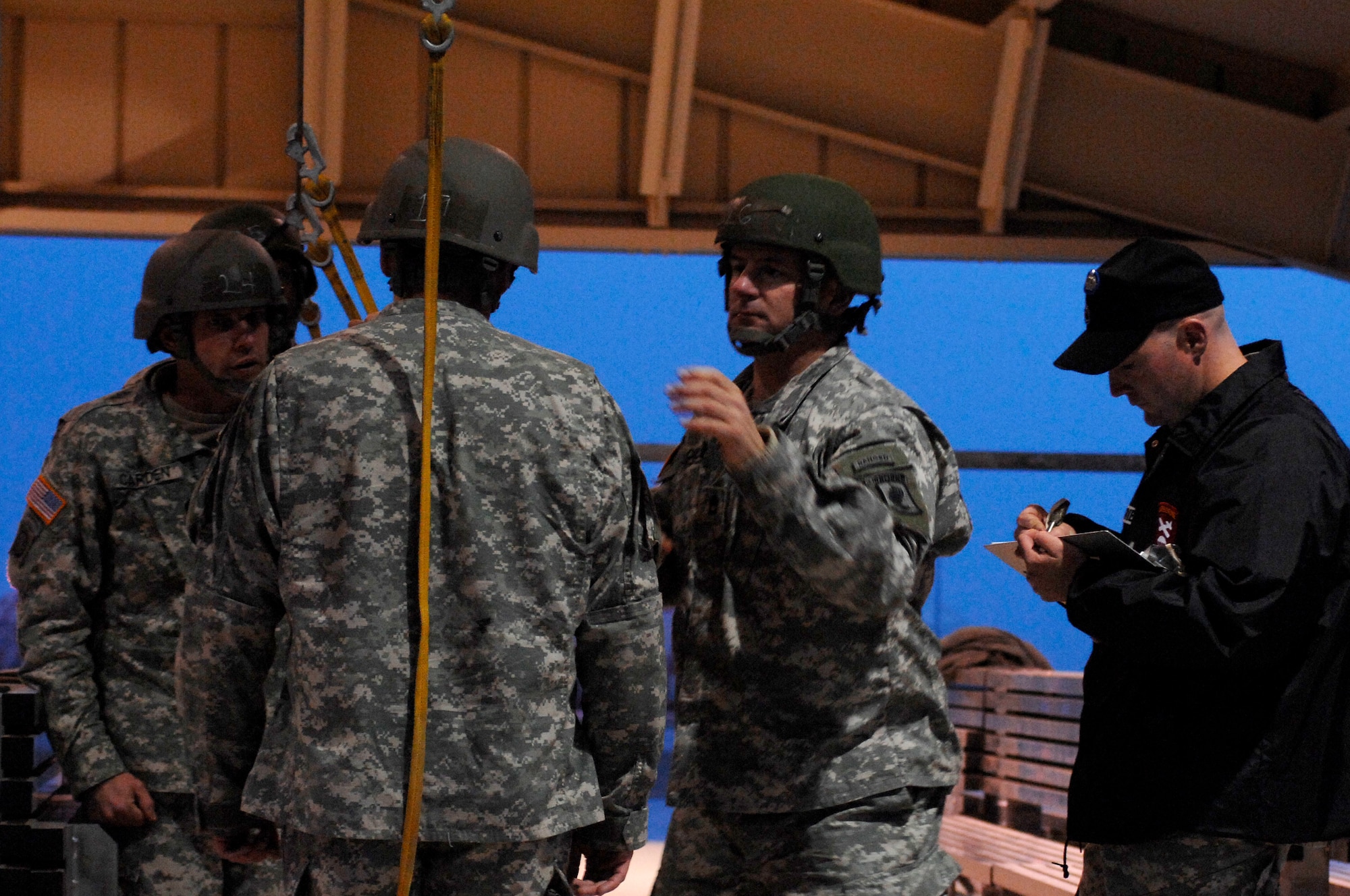 AVIANO AIR BASE, Italy:  An instructor from the Advanced Airborne School at Fort Benning, Georgia reassures jumpmaster students are following proper procedure throughout the aircraft portion of their training Feb 10 at the Personnel Alert Holding Area on Area F.  The PAHA is used by the Army to do sustained airborne training prior to every jump.  (U.S. Air Force photo/Airman 1st Class Ashley Wood)   