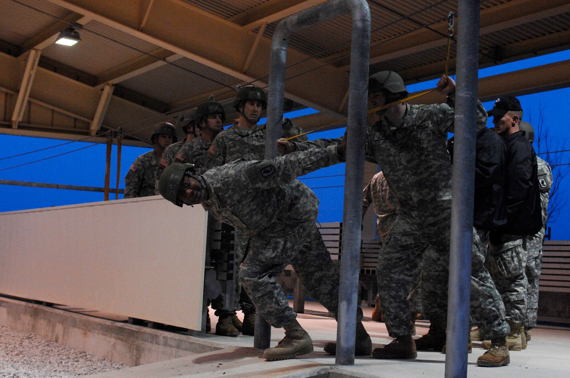 AVIANO AIR BASE, Italy:  An Army jumpmaster practices final door checks before standing his first jumper in the door.  The mock door trainer is part of the Personnel Alert Holding Area located on Area F.  The PAHA is used by the Army to do sustained airborne training prior to every jump.  (U.S. Air Force photo/Airman 1st Class Ashley Wood)  