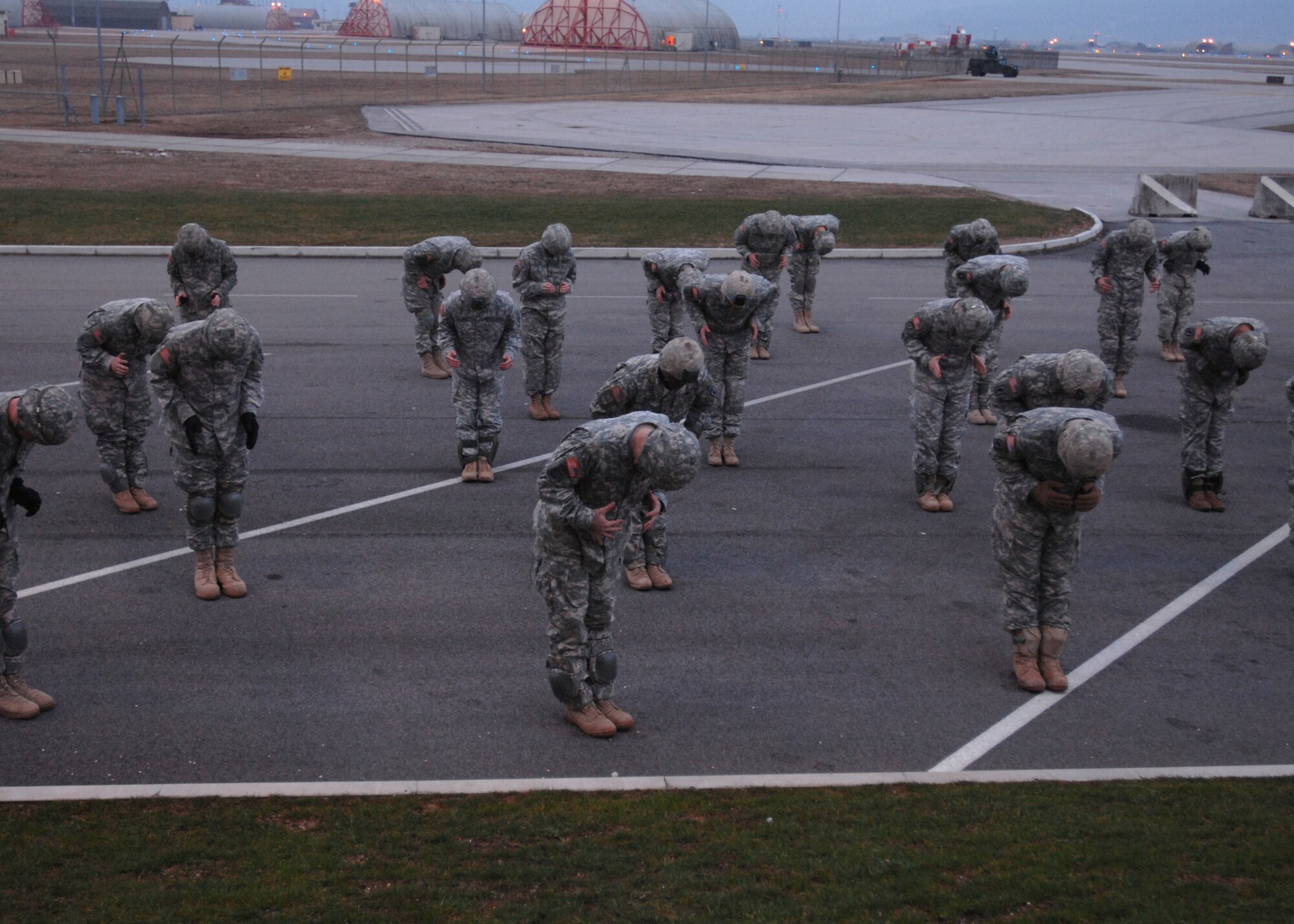 AVIANO AIR BASE, Italy:  Soldiers from the 173rd Airborne Brigade, referred to as jumpers, practice the proper form for exiting an aircraft Feb. 10 outside the Personnel Alert Holding Area located on Area F.  This training is part of the sustained airborne training that is required before every jump. (U.S. Air Force photo/Airman 1st Class Tabitha M. Mans)