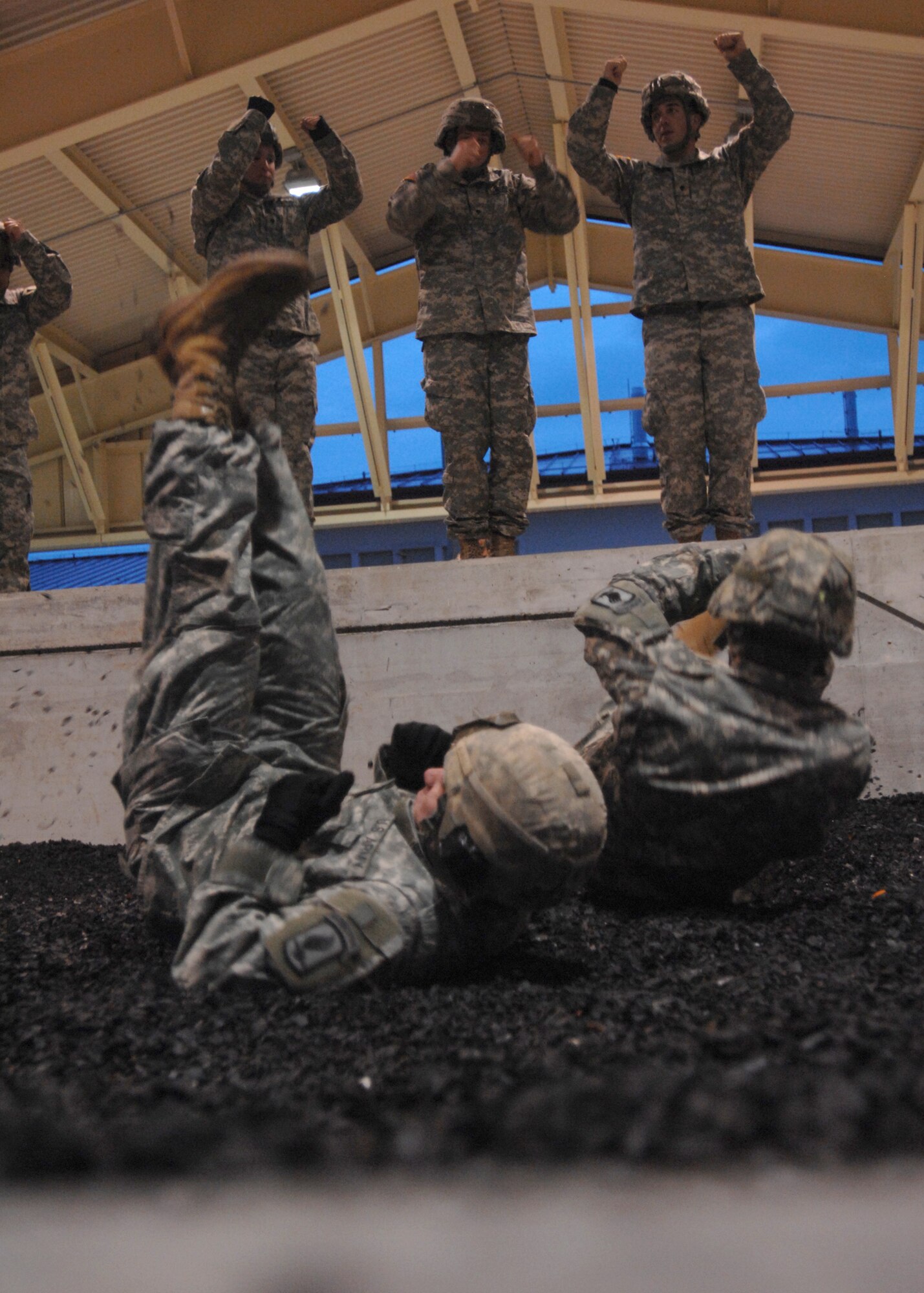 AVIANO AIR BASE, Italy: Soldiers from 173rd Airborne Brigade, referred to as jumpers, practice parachute landing falls Feb. 10 at the PLF pit outside the Personnel Alert Holding Area located on Area F.  All jumpers are required to do four practice falls before doing static line jumps from an Air Force C-130 Hercules. (U.S. Air Force photo/Airman 1st Class Tabitha M. Mans)

 