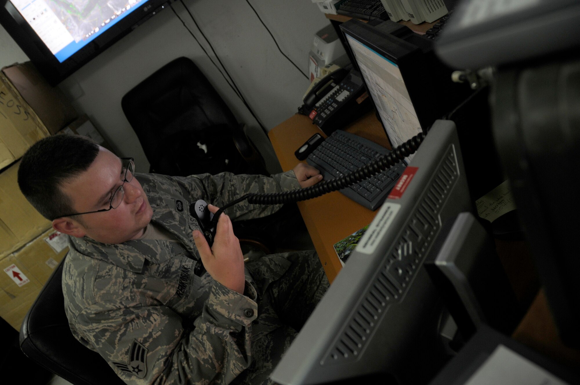 SOUTHWEST ASIA - Senior Airman Matthew Renkosiak, 380th Expeditionary Operations Support Squadron, weather flight, uses a radio to communicate a weather update to a KC-10 pilot in the air, Feb 23. The weather flight is responsible for keeping the base and flyers updated on current weather conditions as well as relaying to aircraft in the sky any changes that might affect their flight. Airman Renkosiak is deployed from Beale AFB, Calif. and hails from Chicago, Ill.  (U.S. Air Force photo by Senior Airman Brian J. Ellis) (Released)