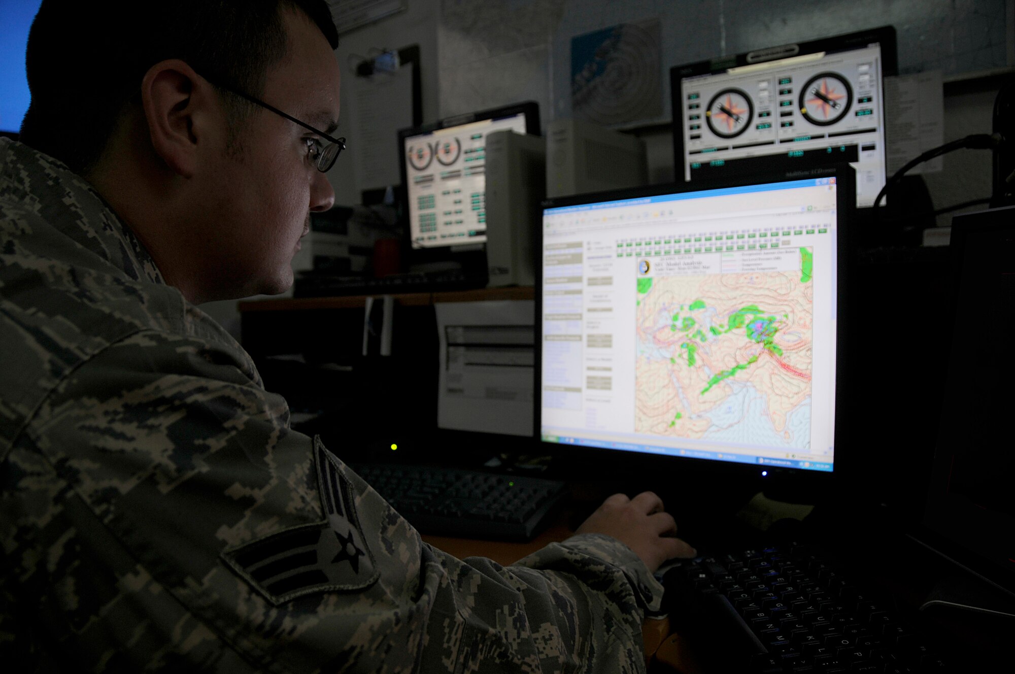 SOUTHWEST ASIA - Senior Airman Matthew Renkosiak, 380th Expeditionary Operations Support Squadron, weather flight, checks the weather to update slides for pilots preparing to fly, Feb 23. The weather flight is responsible for keeping the base and flyers updated on current weather conditions as well as relaying to aircraft in the sky any changes that might affect their flight. Airman Renkosiak is deployed from Beale AFB, Calif. and hails from Chicago, Ill.  (U.S. Air Force photo by Senior Airman Brian J. Ellis) (Released)