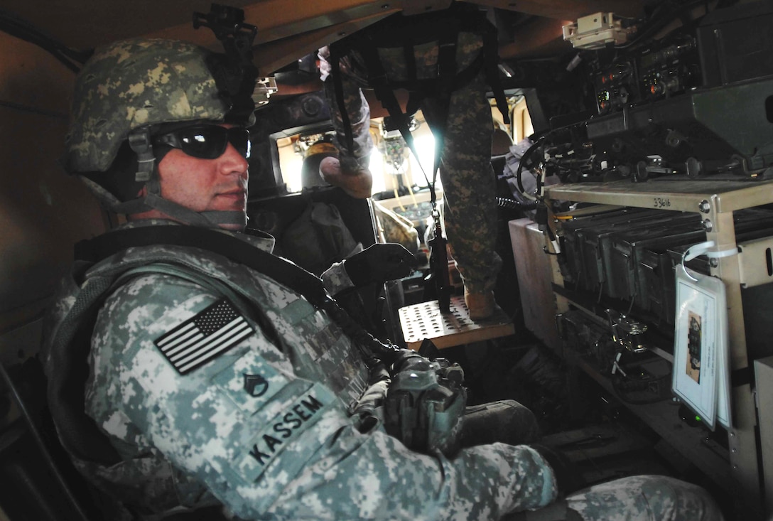 U.S. Army Spc. Eric Sargent Scans The Rooftops And Buildings While ...