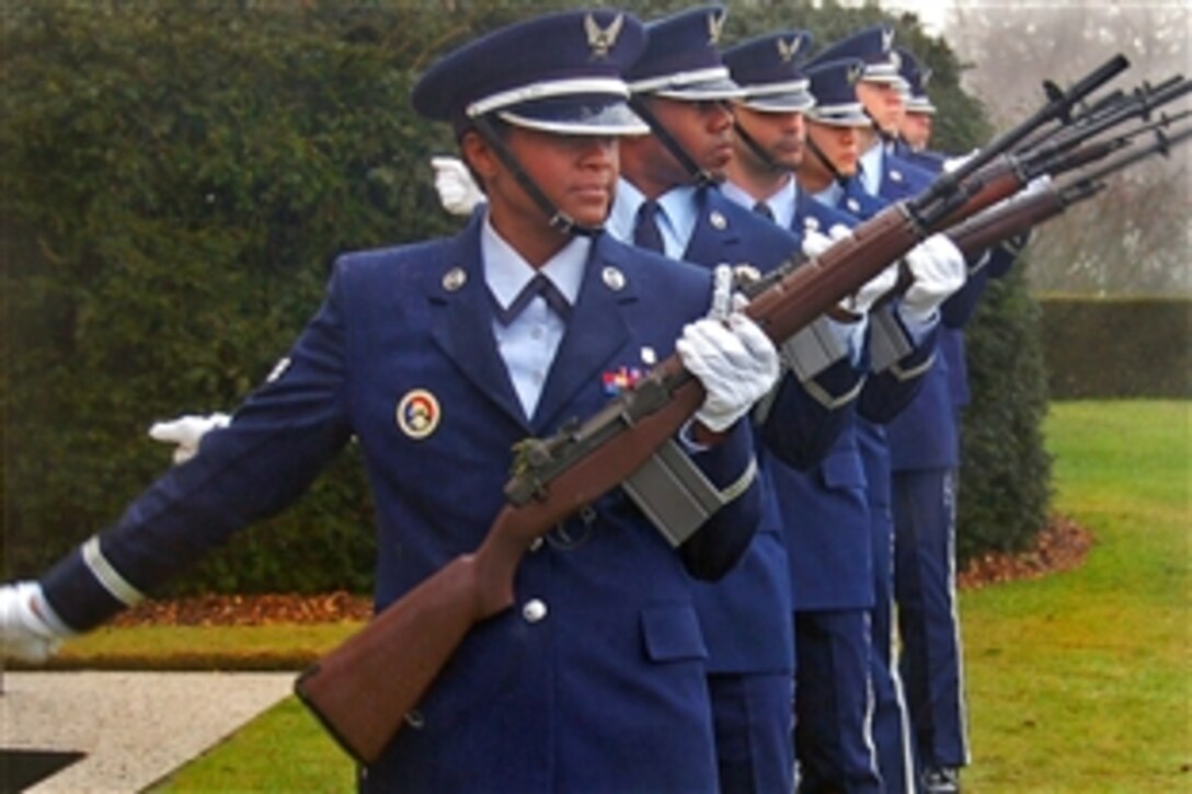 U.S. Air Force Honor guard members from Spangdahlem Air Base, Germany, give a 21-gun salute during a rosette-placing ceremony at the Henri-Chapelle Cemetery and Memorial in Belgium, Feb. 20, 2009. The event honored the nine airmen of the McMurray Crew who flew a B-24 bomber in World War II, and were missing in action until remains were found in a field southwest of Berlin in 2002.