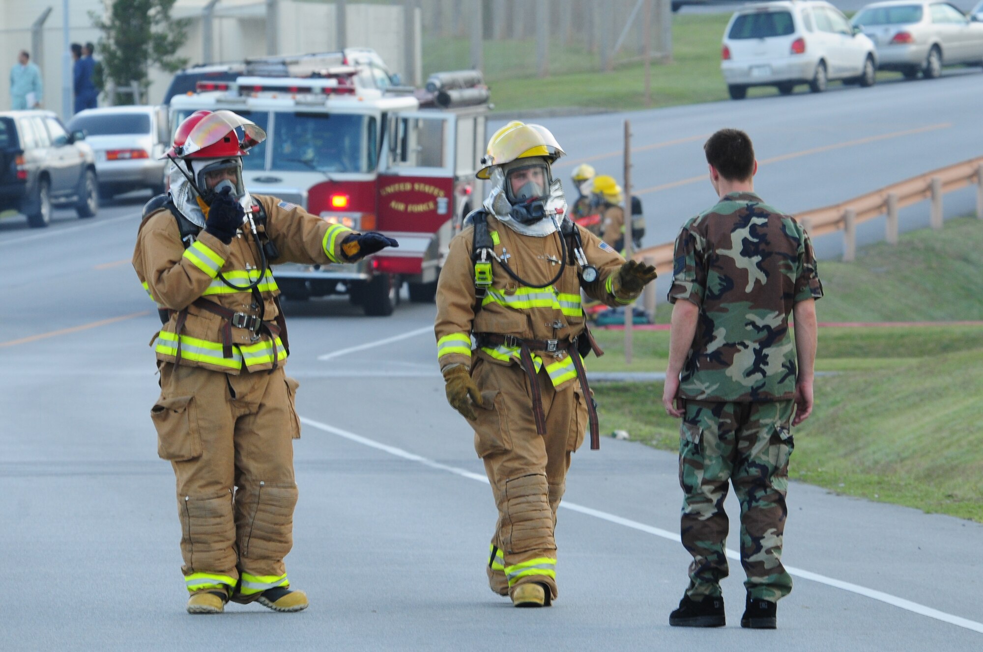18th Wing firefighters stop a simulated accident victim, Airman 1st Class Judd Gregg, from breeching the cordoned perimeter on Kadena Air Base Feb. 26.  The emergency management exercise honed Kadena's response capabilities.  (U.S. Air Force photo/Airman 1st Class Amanda Grabiec)