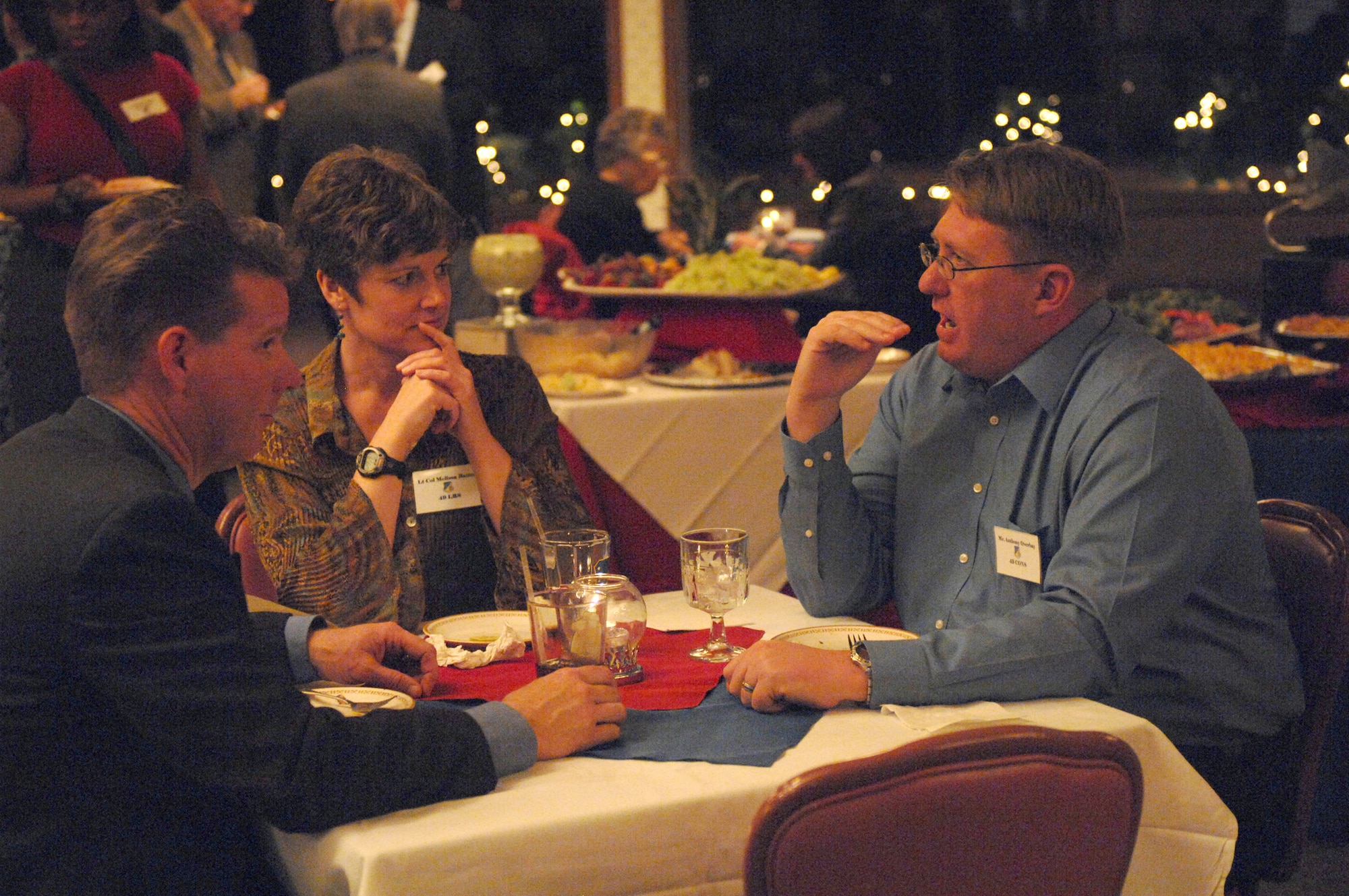 Mr. Anthony Overbay, 49th Contracting Squadron vice commander, takes a few minutes to get to know Lt. Col. Melissa Batten, 49th Logistics Readiness Squadron commander, and her honorary commander, Tim McGinn, owner of McGinn?s Pistachio Ranch during a reception held for the 2009 Holloman honorary commanders. The Honorary Commander Program is designed to increase public awareness and understanding of the armed forces and the missions, policies, programs and people assigned to Holloman and its tenant units. (U.S. Air Force photo/Senior Airman Russell Scalf)