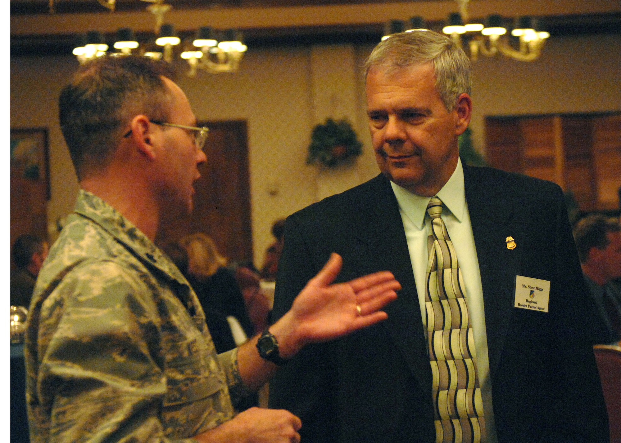 Lt. Col. John West, 49th Security Forces Squadron commander, discusses issues related to law enforcement with his honorary commander, Mr. Steve Higgs, U.S. Border Patrol agent, during a reception at the Raptor?s Nest on Holloman Air Force Base, N.M., for honorary commanders. (U.S. Air Force photo/Senior Airman Russell Scalf)