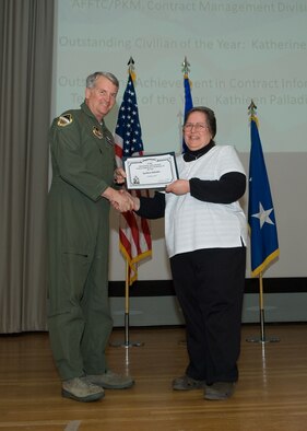 Maj. Gen. David Eichhorn (left), Air Force Flight Test Center commander, presents the Air Force Materiel Command Outstanding Achievement in Contract Information Technology award to Kathy Palladino, 95th Air Base Wing, during a ceremony at the base theater Feb. 24. (Air Force photo by Mike Yncera)