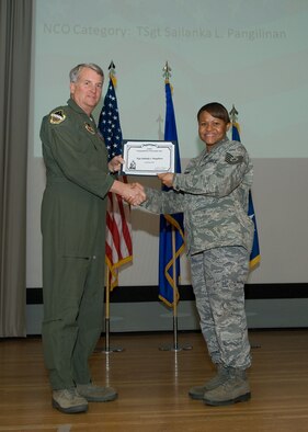 Maj. Gen. David Eichhorn (left), Air Force Flight Test Center commander, presents the Air Force Materiel Command's Command Post Noncommissioned Officer of the Year award to Tech. Sgt. Sailanka L. Pangilinan, 95th Air Base Wing, during a ceremony at the base theater Feb. 24. (Air Force photo by Mike Yncera)