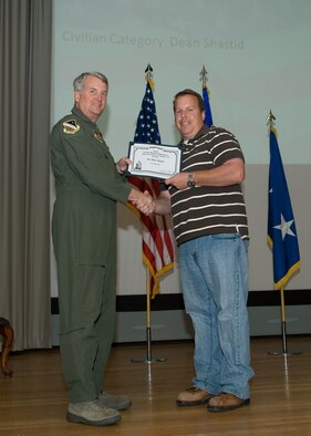 Maj. Gen. David Eichhorn (left), Air Force Flight Test Center commander, presents the Munitions and Maintenance Supervisor Leo Marquez of the Year award to Dean Shastid, 412th Test Wing, during a ceremony at the base theater Feb. 24. (Air Force photo by Mike Yncera)