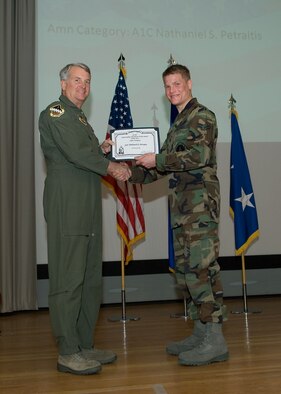 Maj. Gen. David Eichhorn (left), Air Force Flight Test Center commander, presents the Air Force Materiel Command to Outstanding Munitions Airman of the Year award to Airman 1st Class Nathaniel S. Petraitis, 412thTest Wing, during a ceremony at the base theater Feb. 24. (Air Force photo by Mike Yncera)