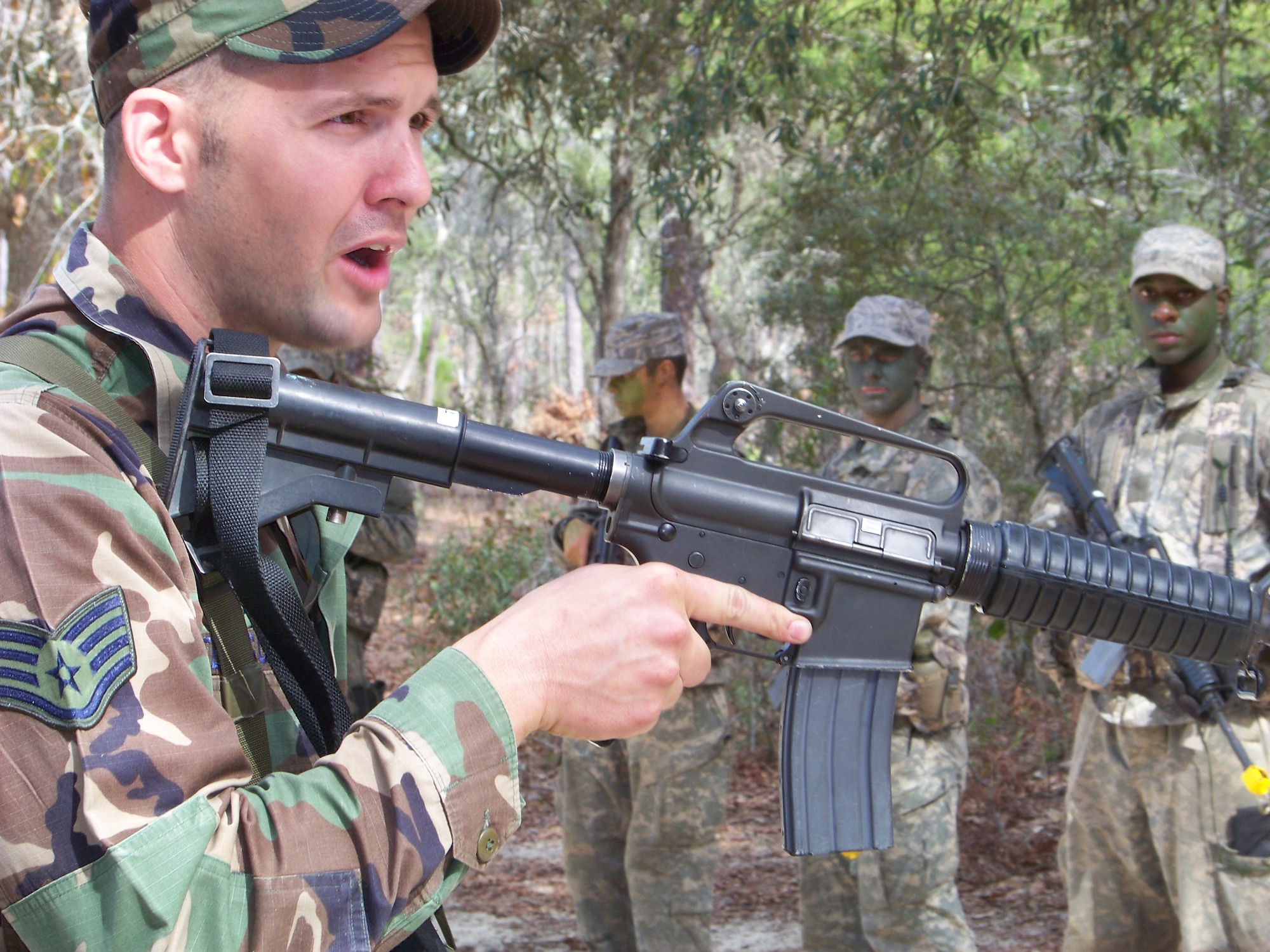 HURLBURT FIELD, Fla. -- Staff Sgt. Stewart Ferguson, a 342nd Training Squadron tactical air control party instructor gives students a weapons refresher lesson during a portion of their field training here, Feb. 12. TACPs act as a liaison between U.S. Army ground maneuver units and Air Force pilots. The TACP technical training school involves rigorous academic and physical training standards. (U.S. Air Force photo by Staff Sgt. Mareshah Haynes)