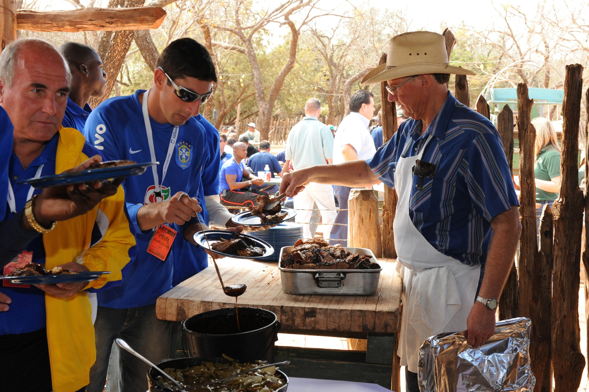 BUFFALO GAP, Texas -- Members from the Conseil International du Sport Militaire (CISM) competition are served lunch by the Perini Ranch Steakhouse staff here, Feb 24.  The day was filled visiting the Buffalo Gap Historical Village, Perini Ranch Steakhouse, Frontier Texas, and a trip to the Abilene Mall.  The men?s military soccer championship was hosted by Dyess Air Force Base and promoted by the International Military Sports Council to form friendship through sports with different countries.  (U.S. Air Force photo by Staff Sergeant Connor Estes).      
