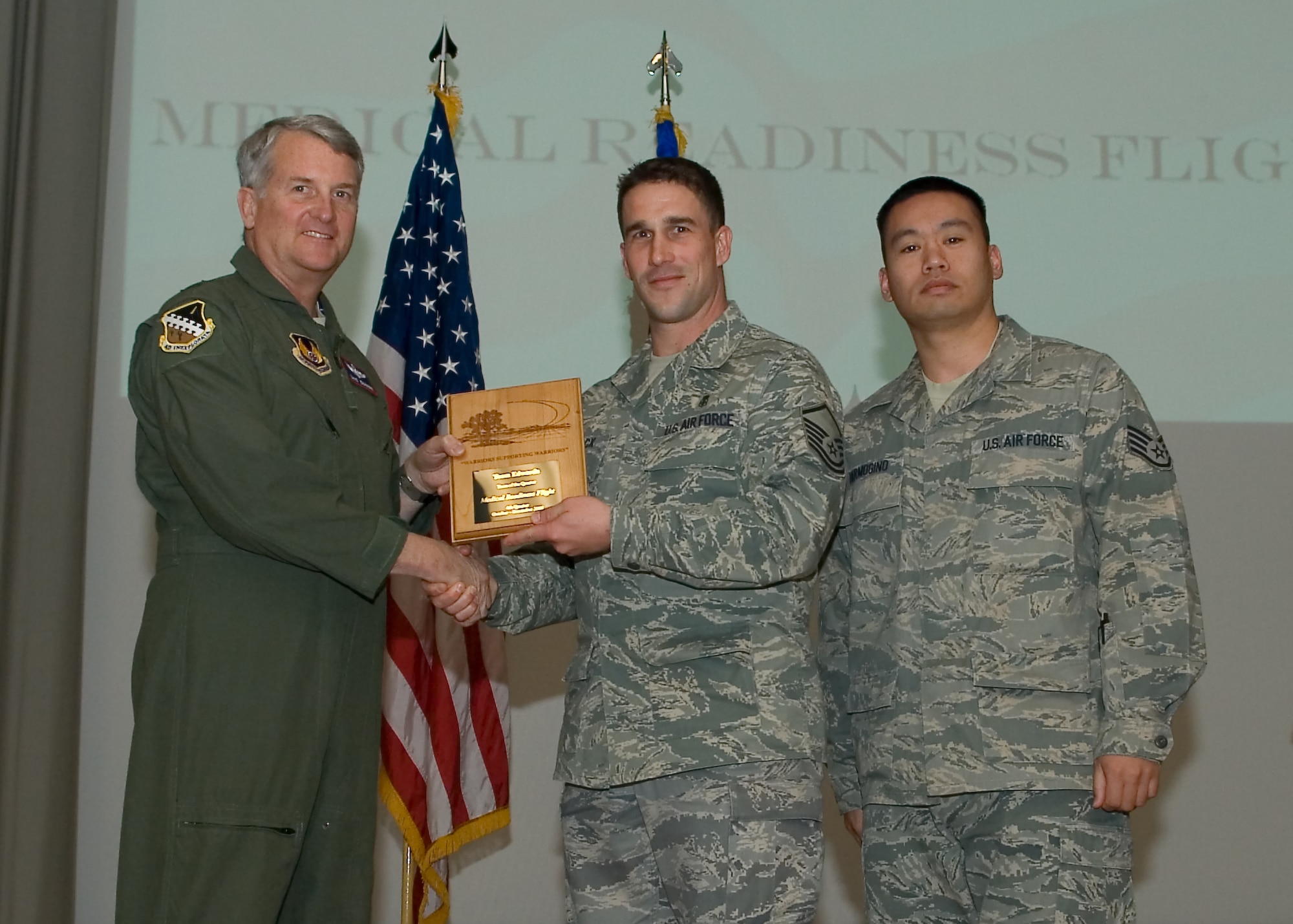 Maj. Gen. David Eichhorn (left), Air Force Flight Test Center commander, presents members of the 95th Medical Support Squadron with the Team of the Fourth Quarter award during a ceremony at the base theater Feb. 24. (Air Force photo by Mike Yncera)