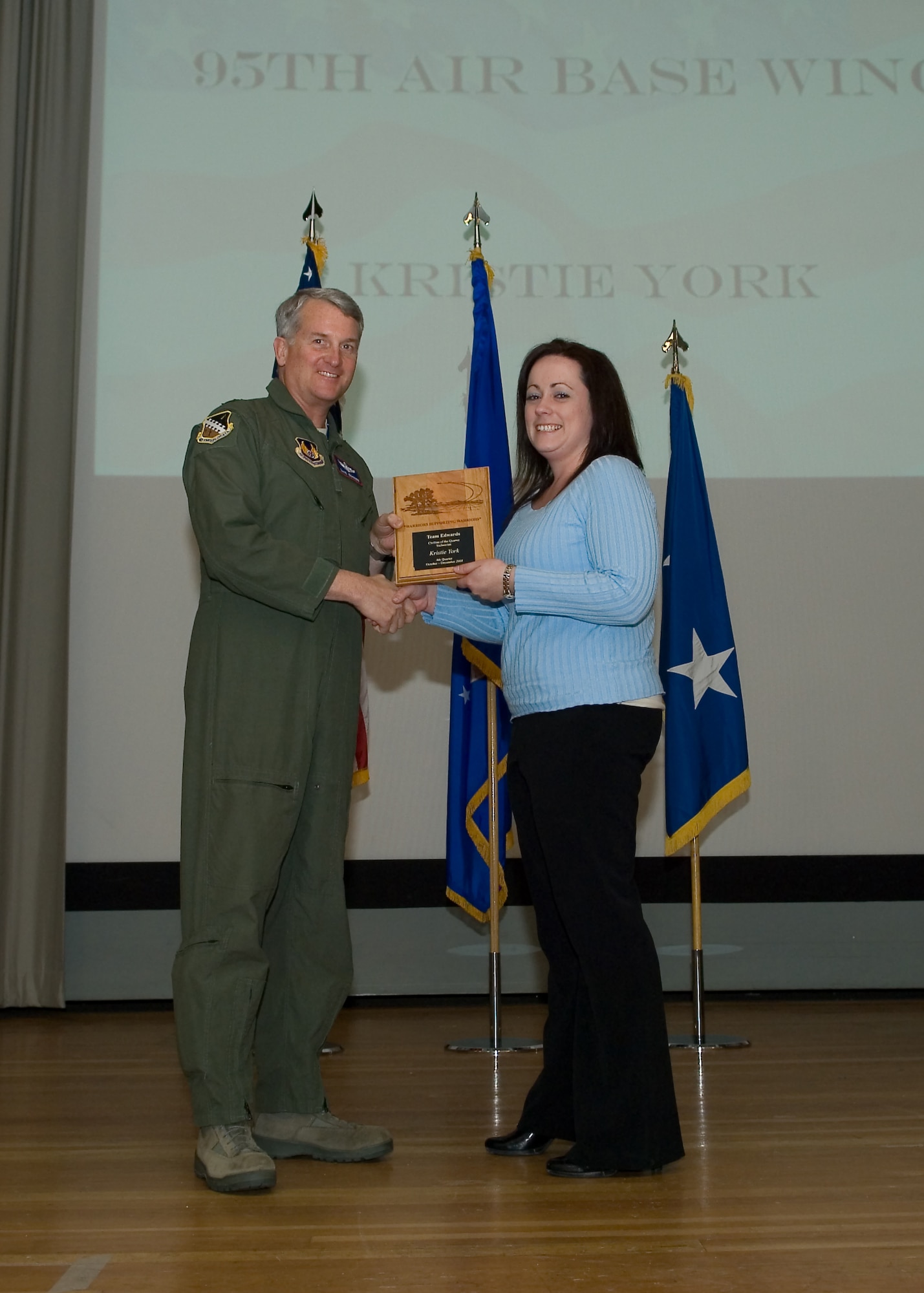 Maj. Gen. David Eichhorn (left), Air Force Flight Test Center commander, presents Kristie York, 95th Aerospace Medicine Squadron with the Technician Civilian of the Fourth Quarter award during a ceremony at the base theater Feb. 24. (Air Force photo by Mike Yncera)