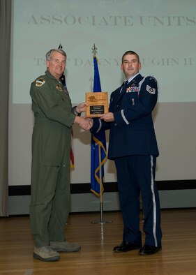 Maj. Gen. David Eichhorn (left), Air Force Flight Test Center commander, presents Tech. Sgt. Danny Vaughn II, 31st Test Evaluation Squadron with the Noncommissioned Officer of the Fourth Quarter award during a ceremony at the base theater Feb. 24. (Air Force photo by Mike Yncera)