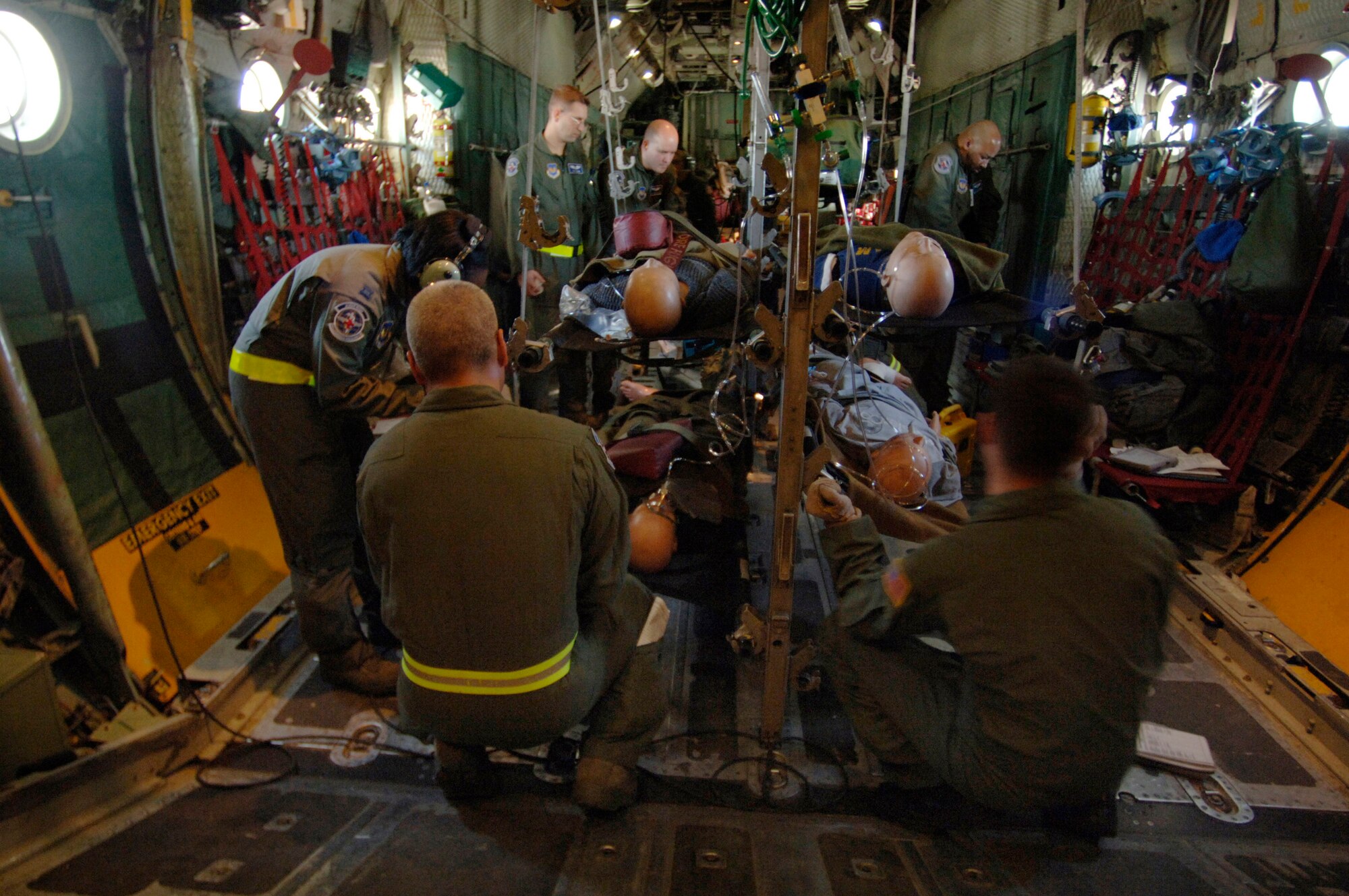 Flight nurses and medical technicians follow a checklist detailing how to properly secure patients and medical equipment for a potentially rough landing in preparation for an emergency landing training scenario Feb. 19 aboard a C-130 Hercules flying over southern Germany. The flight-qualified healthcare providers, assigned to the 86th Aeromedical Evacuation Squadron, fly weekly with the 37th and 38th Airlift Squadron's C-130 fleet to remain proficient in their skills. (Defense Department photo/Master Sgt. Scott Wagers) 
