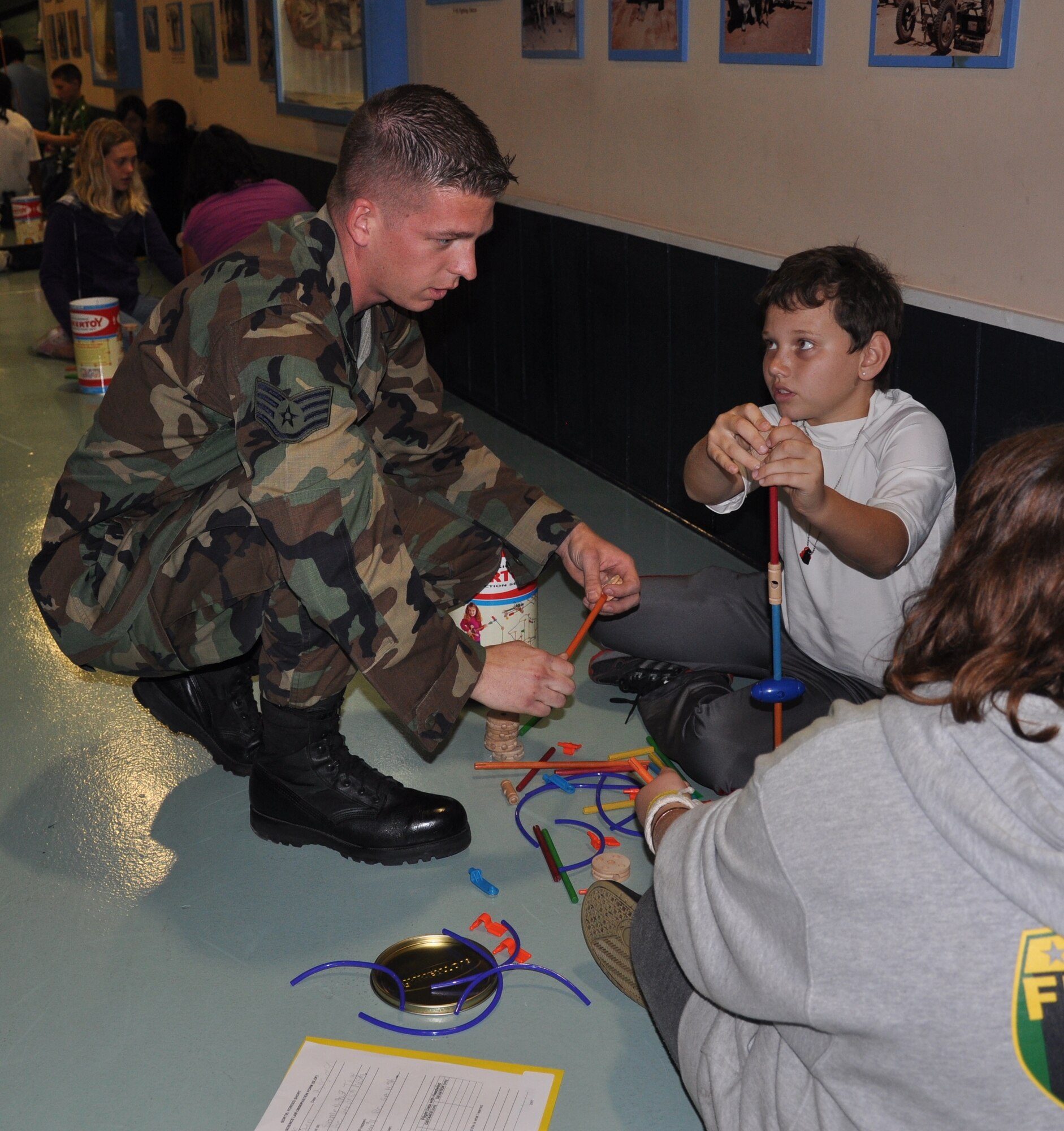 EGLIN AIR FORCE BASE, Fla. -- Staff Sgt. Bradley Barkley, a volunteer from the 33rd Fighter Wing, helps Dustin Ethridge, Shalimar Elementary School student, build a tower out of Tinker Toys during the school's "Engineers for America" program at the Air Armament Museum here Feb. 18-19. (U.S. Air Force photo/Chrissy Cuttita)
