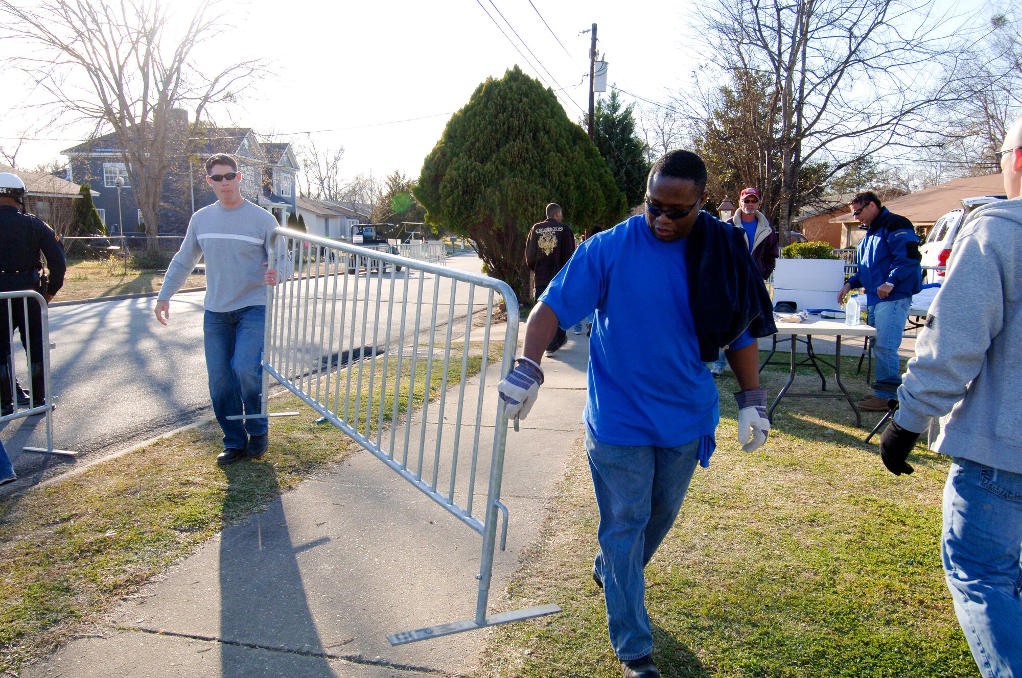 Capt. Andrew Spady (left), an Officer Training School flight commander, and Capt. Eric Tatum, an Air University Plans and Programs officer, spend their Monday removing a barrier from the two-story home built for the “Extreme Makeover: Home Edition” television series. More than 80 volunteers from Maxwell spent many hours off-duty in support of the construction of a home for a needy Montgomery family. According to Maj. Freddie Goldwire, 42nd Air Base Wing coordinator for the support, Maxwell volunteers were involved in all phases of the construction and clean-up. (Air Force photo by Donna Burnett)