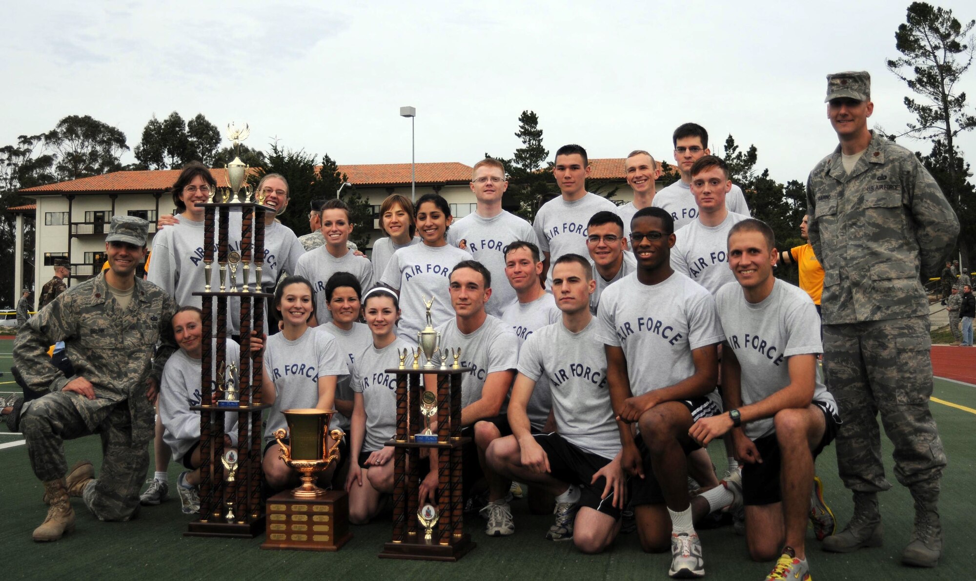 PRESIDIO OF MONTEREY, Calif. -- On Feb. 4, the 311th and 314th Training Squadrons combined run team won the Presidio of Monterey, Installation Commander's Cup.  According to the captain of the female run team, communication and team work were key to this win. The quarterly competition consists of a two-mile formation run with guidon at the Price Fitness Center Track. Each of the four services enters one eight-person male team and one eight-person female team.  The 311/314 TRS female Airmen placed first and completed the run in 14:05 seconds.  The male Airmen completed the race in 11:59 seconds coming in second behind the Marines. Teams practice three times a week running up to 7 miles up and down the steep hills of Monterey. The training paid off in a big way as one of the Airmen recently qualified for the Boston Marathon and plans to run in the upcoming Big Sur Marathon. (U.S. Air Force photo)
