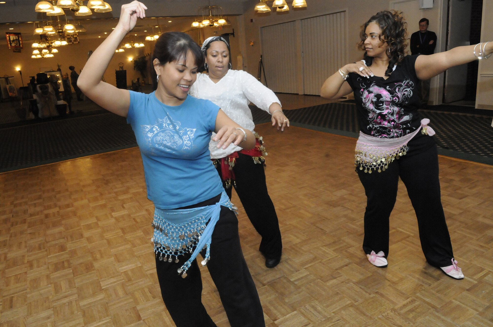 L-R, Riza Dostie, Tech Sgt. Sa'Rita Williams, instructor, and Staci Curry practice steps during belly dancing class at the community center Feb. 24. U. S. Air Force photo by Sue Sapp