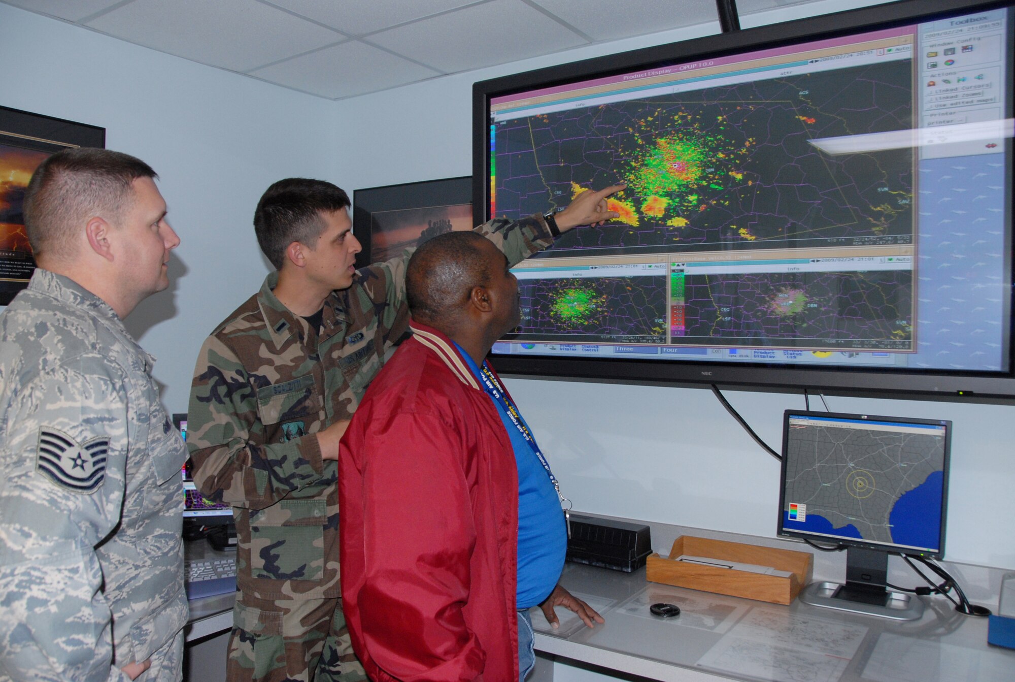 1st Lt. Jason Scalzitti, 78th Operations Support Squadron,center, points out weather signatures on the base Doppler Radar system to his coworkers Tech. Sgt. Brad Godwin and  Roddy Nixon Jr. U.S. Air Force photo by 2nd Lt. Chrissy Keeley