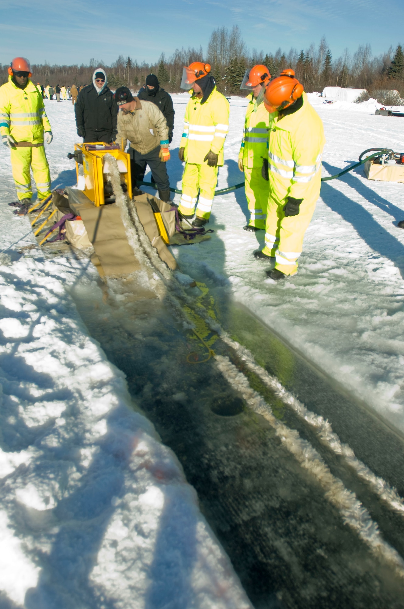 ELMENDORF AIR FORCE BASE, Alaska -- Members from the 611th Civil Engineer Squadron run the mop rope to practice collecting oil Feb. 24, 2009.  The mop rope is one of the techniques used for collecting oil. (U.S. Air Force photo by Senior Airman Jonathan Steffen)
