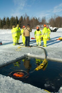 ELMENDORF AIR FORCE BASE, Alaska -- Ice operations participants use a Weir skimmer to suck water and oil into a filter plate. Ice Operations were on the base's Sixmile Lake to practice oil spill recovery tactics. (U.S. Air Force photo/Senior Airman Jonathan Steffen) 
