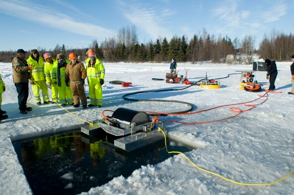 ELMENDORF AIR FORCE BASE, Alaska -- Members from the 611th Civil Engineer Squadron run the drum skimmer to collect oil. (U.S. Air Force photo/Senior Airman Jonathan Steffen)