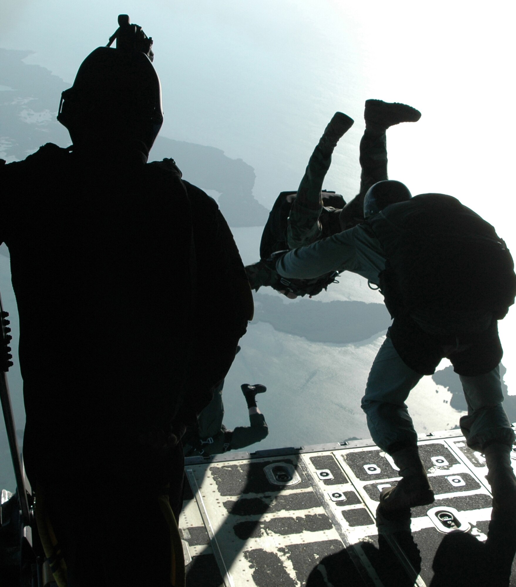 Members of the U.S. Navy's Special Boat Team 20 leap into the Florida sky Feb. 26, 2009, during a special warfare training mission at Naval Air Station Key West, Fla. The joint training opportunity allows both Airmen and Sailors to accomplish specialized training for high-altitude, low-opening, or 'HALO' jumps. The Sailors flew with the Air Force Reserve Command's 302nd Airlift Wing from Peterson Air Force Base, Colo. (U.S. Air Force photo/Senior Airman Stephen Collier)