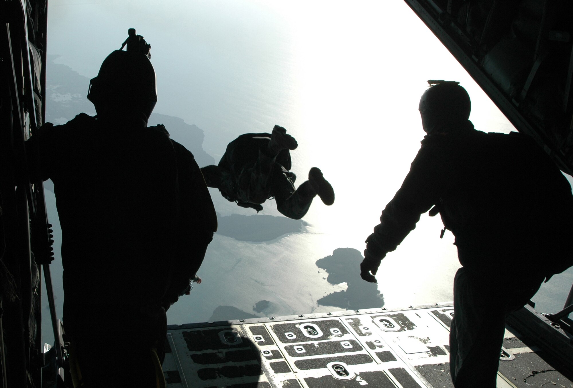 Members of the U.S. Navy's Special Boat Team 20 leap into the Florida sky Feb. 26, 2009, during a special warfare training mission at Naval Air Station Key West, Fla. The Naval special forces members partnered up with the Air Force Reserve Command's 302nd Airlift Wing from Peterson Air Force Base, Colo., to support the refresher training for high-altitude, low-opening, or 'HALO' jumps. Known as Special Warfare Combatant Craft, or 'SWCCs,' the special forces members support Navy SEALs with all maritime missions, involving a variety of craft for different, specialized missions. (U.S. Air Force photo/Senior Airman Stephen Collier)