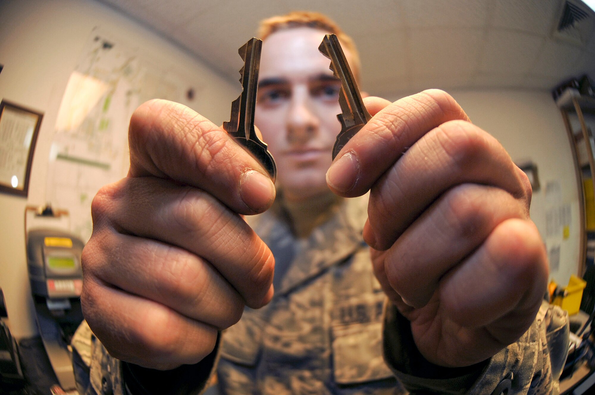 Senior Airman Jesse Testudine checks for any discrepancies on a newly made key by comparing it to the original Feb. 25 at an air base in Southwest Asia. Airman Testudine and fellow locksmiths make an estimated 430 keys a month for new personnel, new building structures and to replace lost keys. Airman Testudine is a locksmith with the 379th Expeditionary Civil Engineer Squadron and is deployed from Misawa Air Base, Japan. He is a native of Baltimore. (U.S. Air Force photo/Staff Sgt. Joshua Garcia) 
