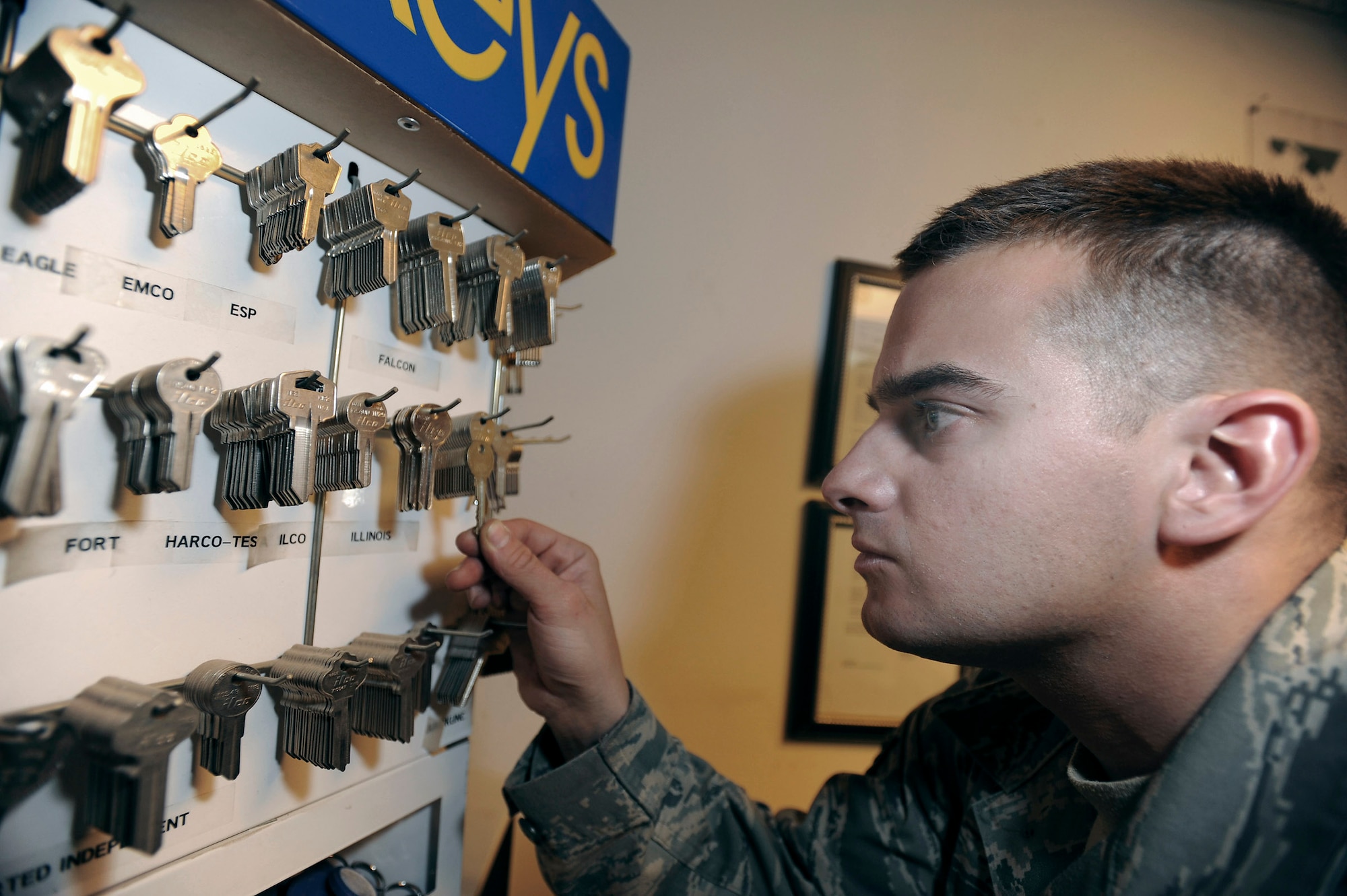 Senior Airman Jesse Testudine searches for the correct key blank to make a duplicate key Feb. 25 at an air base in Southwest Asia. Airman Testudine and fellow locksmiths make around 430 keys a month for new personnel, new building structures and to replace lost keys. Airman Testudine is a locksmith with the 379th Expeditionary Civil Engineer Squadron, and is a native of Baltimore. (U.S. Air Force photo/Staff Sgt. Joshua Garcia) 
