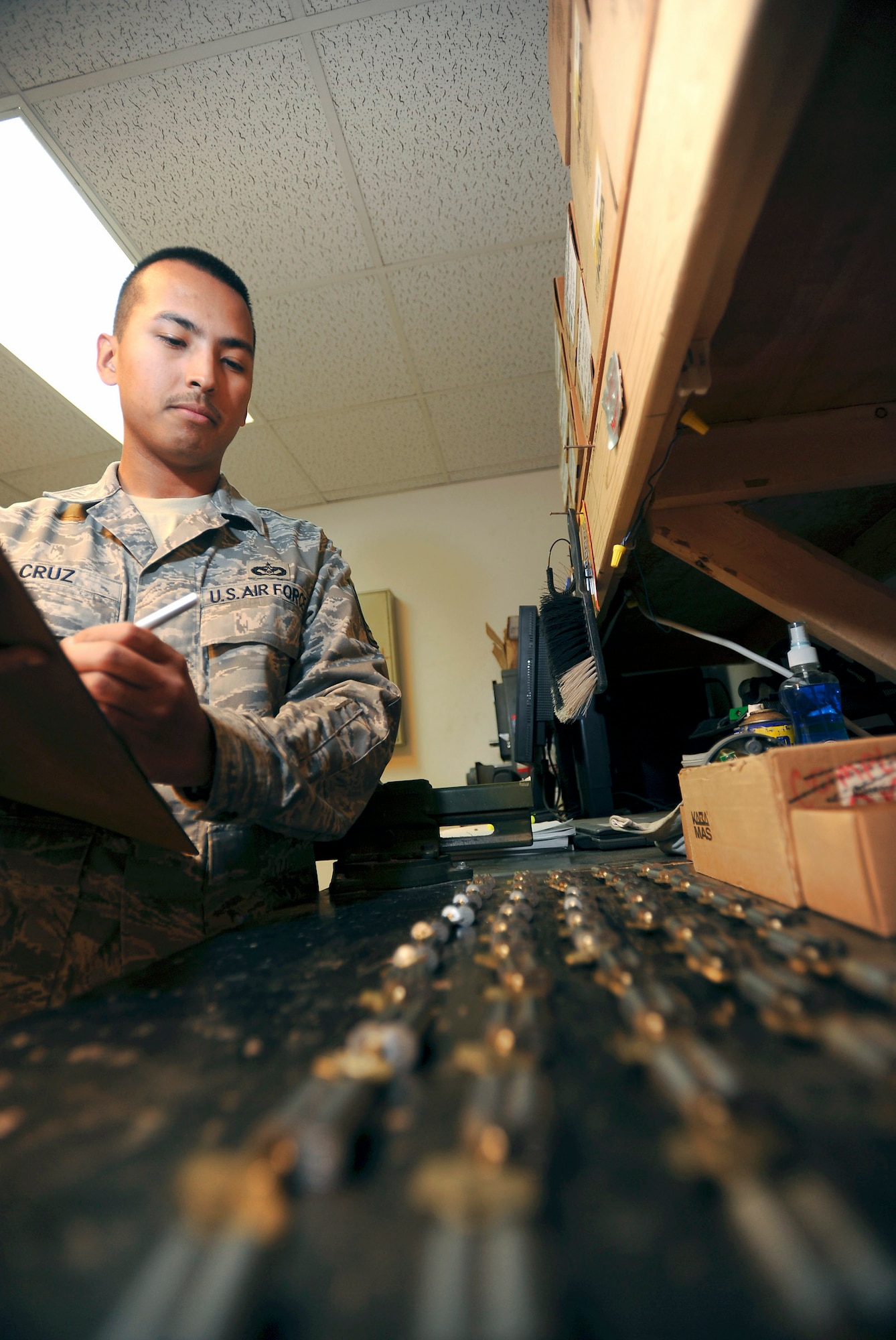 Staff Sgt. Matthew Cruz inventories keys and their corresponding locks before heading out for a job Feb. 25 at an air base in Southwest Asia. The locks will be installed in a brand new facility opening on base in the near future. Sergeant Cruz is a locksmith with the 379th Expeditionary Civil Engineer Squadron, and is deployed from Pope Air Force Base, N.C. He is a native of Tacoma, Wash. (U.S. Air Force photo/Staff Sgt. Joshua Garcia) 
