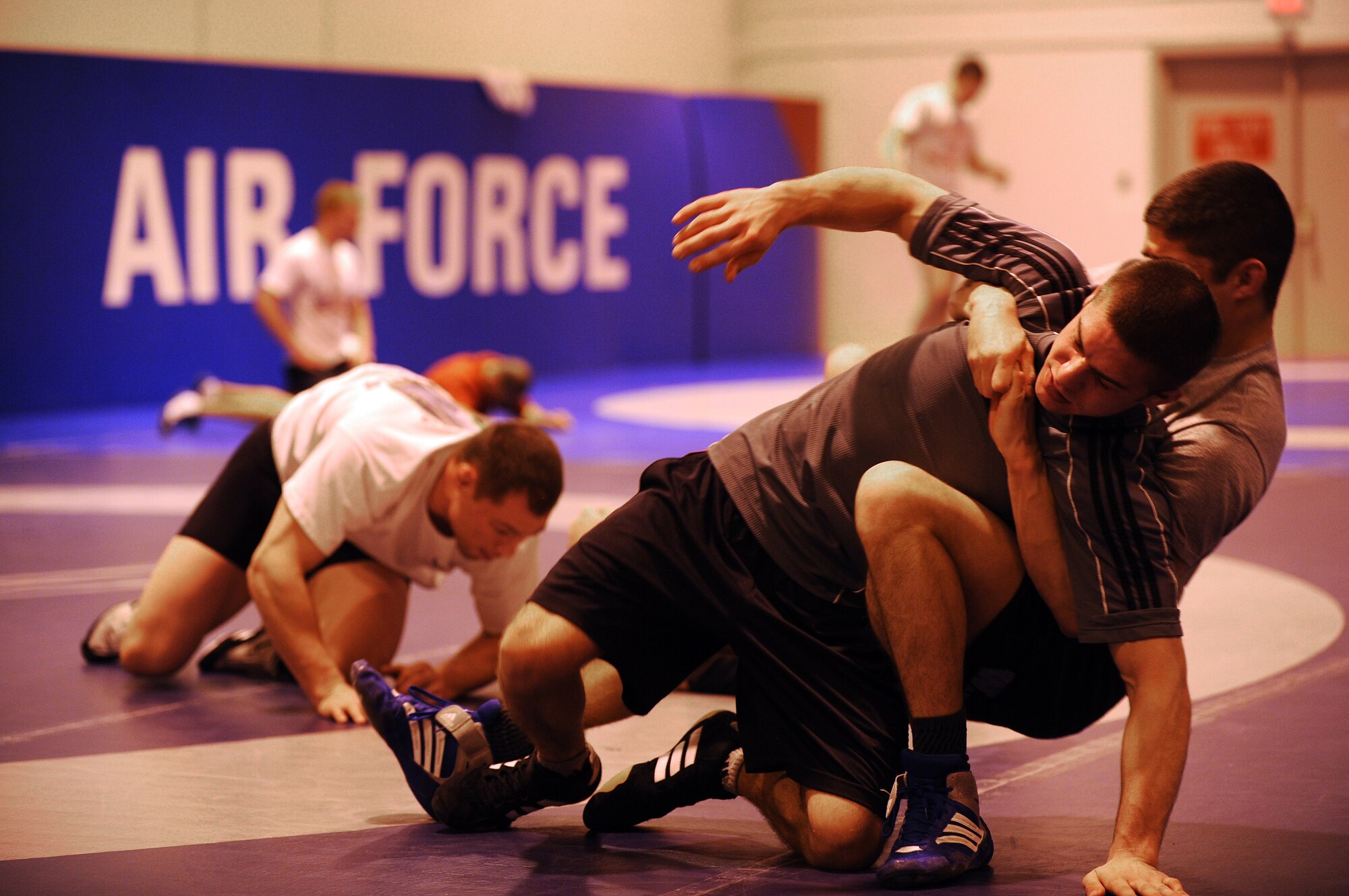 MOUNTAIN HOME AIR FORCE BASE, Idaho -- Senior Airman Dean Maraj from Royal Air Force Croughton, United Kingdom, wrestles Airman Matt Adams from Spangdahlem Air Base, Germany, Feb. 24 during a practice match at the Air Force Wrestling Camp at Mountain Home Air Force Base, Idaho. The Airmen will continue to train until the "wrestle-off" March 7 and 8 when they try out for the Air Force team. (U.S. Air Force photo/ Senior Airman Ryan Crane)