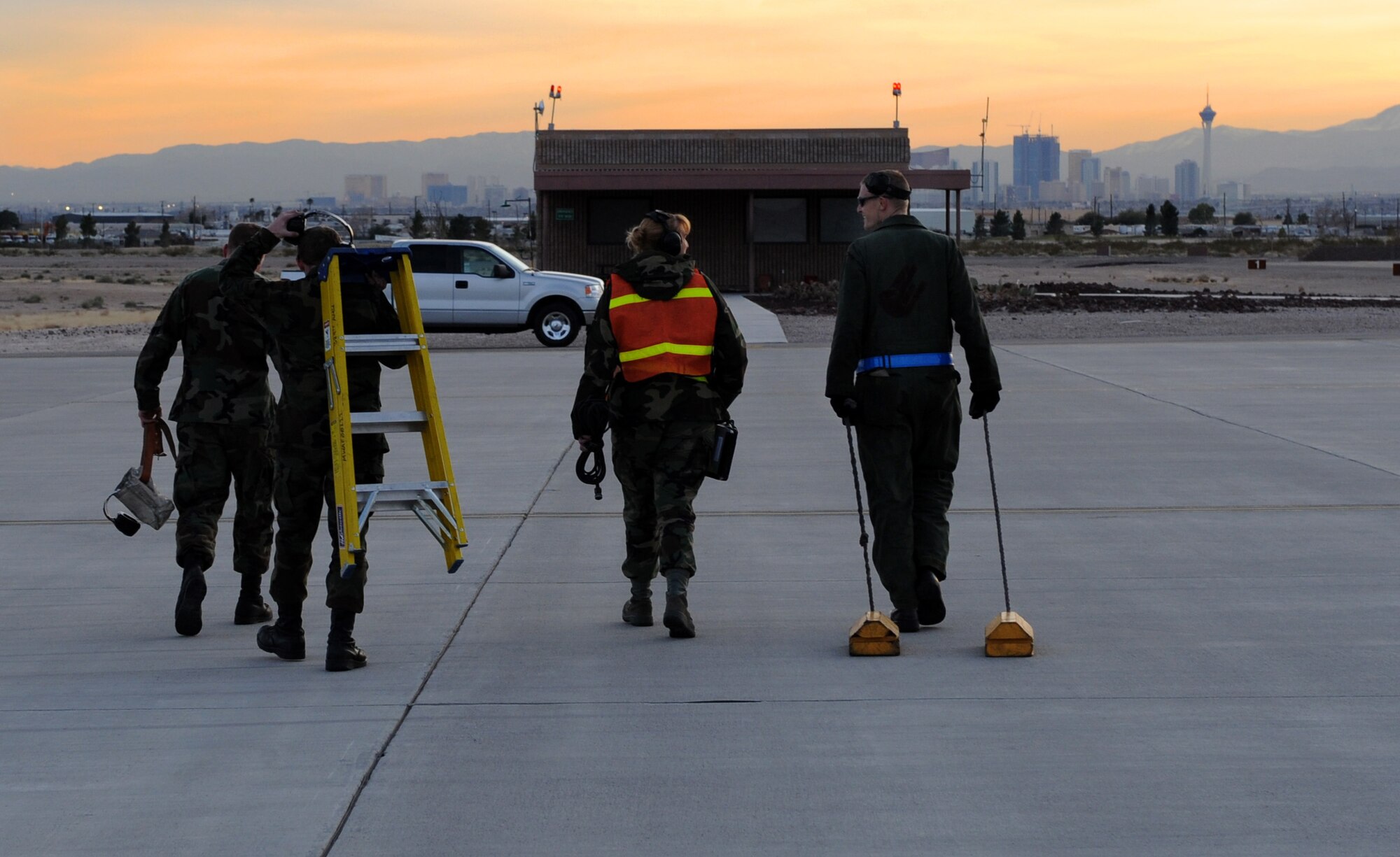 NELLIS AIR FORCE BASE, Nev. -- An aircraft recovery team from the 389th Fighter Squadron stationed out of Mountain Home Air Force Base walks back to their vehicle after recovering F-15E Strike Eagles at Nellis Air Force Base, Nev., that will be participating in Red Flag 09-3 Feb. 20. Red Flag, the Air Force’s largest air-to-air combat training exercise, includes more than 90 aircraft, 2,000 personnel and 27 units. This Red Flag is the first time since 1981 that the exercise will run for three straight weeks. (U.S. Air Force photo by Airman First Class Debbie Lockhart)