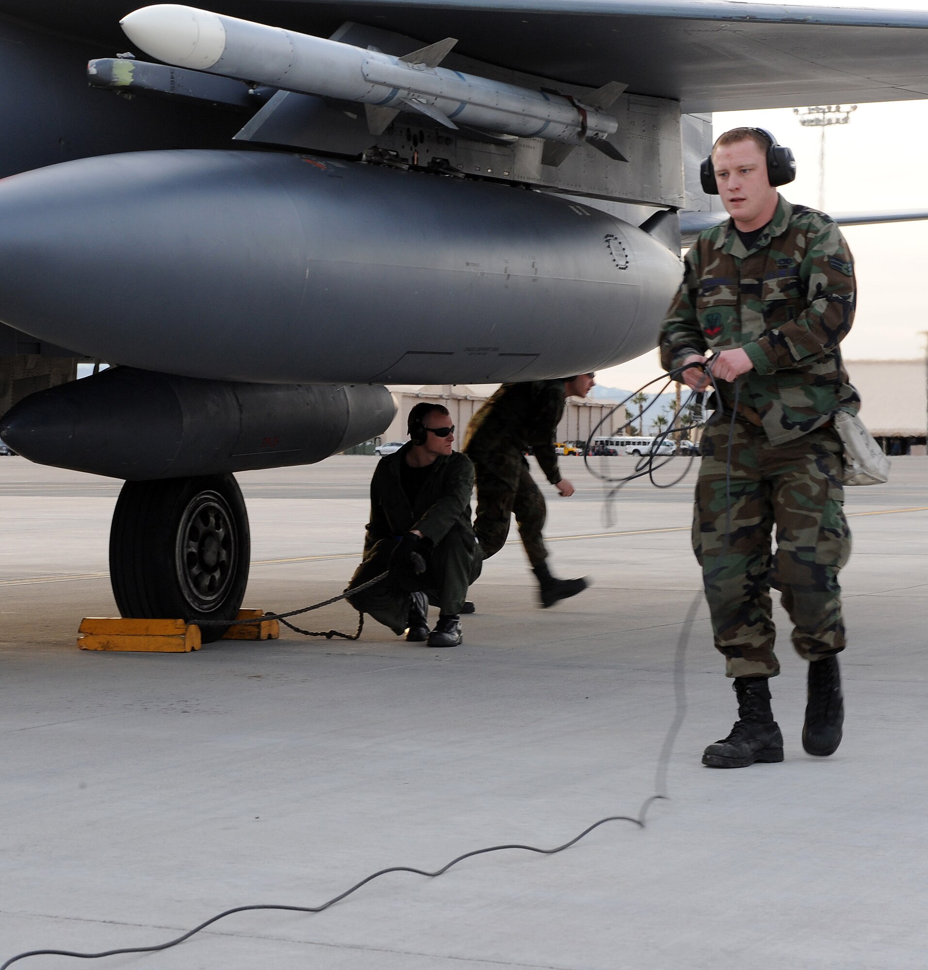 NELLIS AIR FORCE BASE, Nev. -- Senior Airman Mark Chappell, 389th Aircraft Maintenance Unit weapons specialist, wraps up a communications cord while recovering an F-15E Strike Eagle with an aircraft recovery team as they participate in Red Flag 09-3 at Nellis Air Force Base, Nev., Feb. 20. Red Flag, the Air Force’s largest air-to-air combat training exercise, includes more than 90 aircraft, 2,000 personnel and 27 units. This Red Flag is the first time since 1981 that the exercise will run for three straight weeks. (U.S. Air Force photo by Airman First Class Debbie Lockhart)