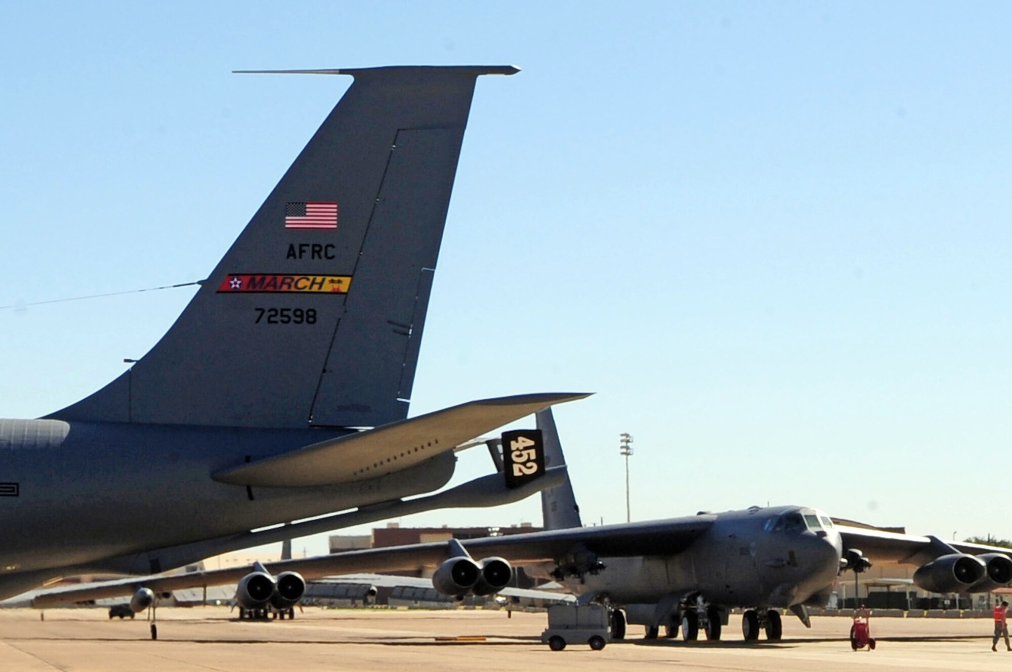 A KC-135 from the 336th Air Refueling Squadron out of March Air Reserve Base, Calif., prepares to take off while a B-52 from the 2d Bomb Wing sits on the runway. The refueler was deployed to Barksdale Air Force Base, La., to participate in refueling training. (Senior Airman Joanna M. Kresge/U.S. Air Force)