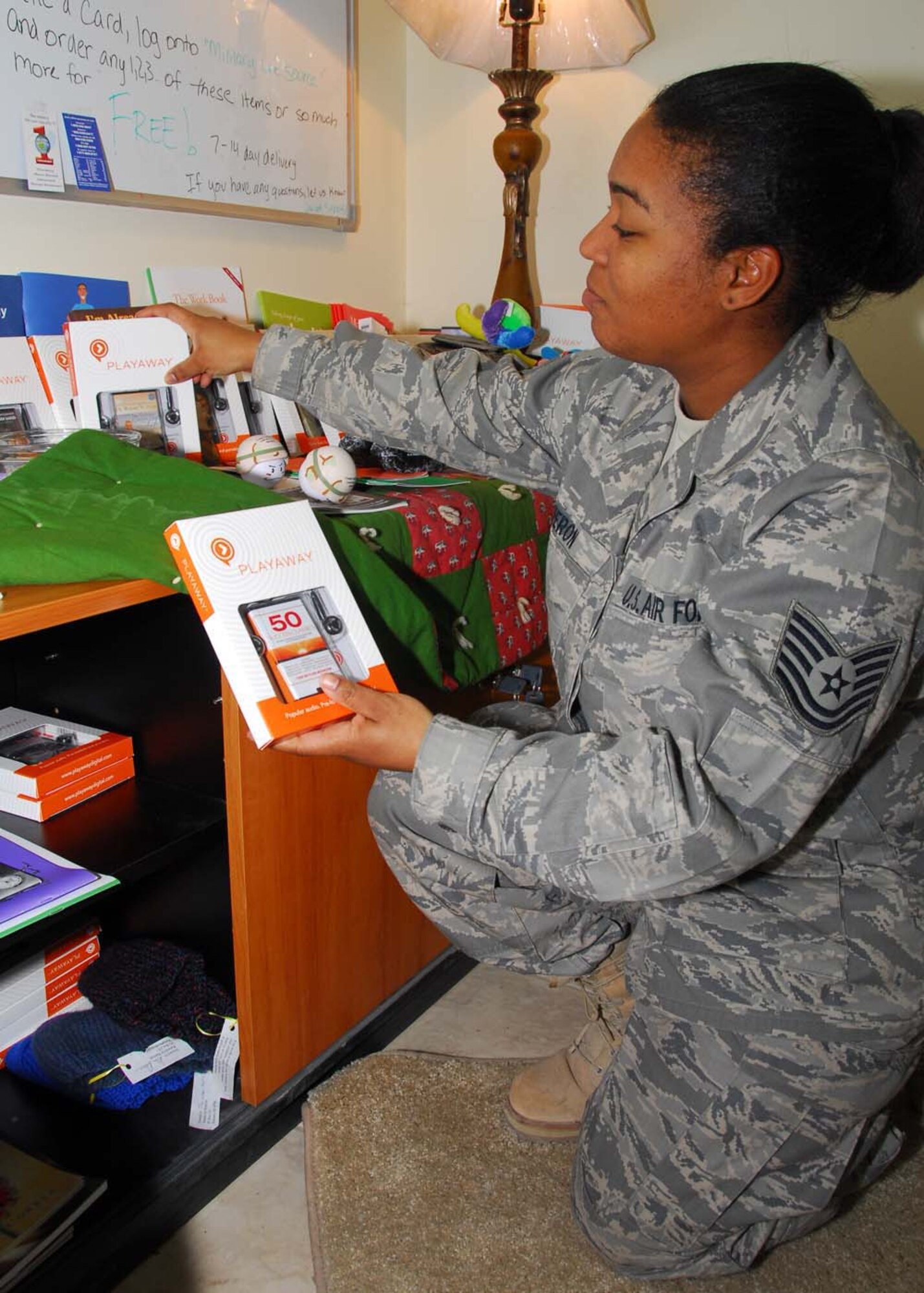 SOUTHWEST ASIA -- Tech. Sgt. Carolyn Heron, 386th Expeditionary Medical Group Combat Stress, restocks digital audio players and pamphlets in the combat stress office at an air base in Southwest Asia, Feb. 25. The support material the combat stress office provides military personnel are given free of charge by Military One Source. (U.S. Air Force photo/ Senior Airman Courtney Richardson)