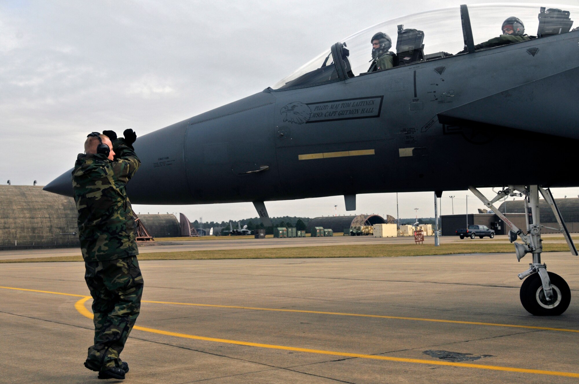 Airman 1st Class Justin Lloyd, 48th Aircraft Maintenance Squadron F-15 crew chief, marshals Capt. Bradley Brandt, 494th Fighter Squadron pilot and Capt. Conor Teegarden, 494th Fighter Squadron weapon system officer, out of the protected aircraft shelter Feb. 11, 2009, at RAF Lakenheath, England. Captain Brandt and Captain Teegarden will perform the rest of the preflight inspection outside of the protected aircraft shelter. (U.S. Air Force photo by Airman 1st Class Perry Aston) 