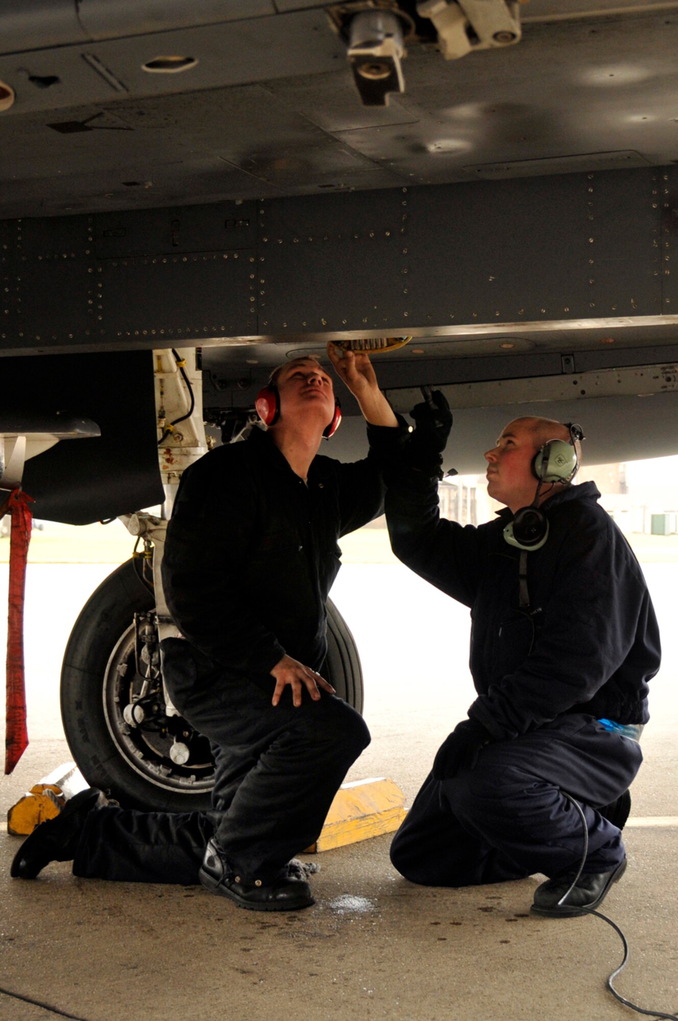 Airman 1st Class Jason Anderson and Senior Airman Charles White, 48th Aircraft Maintenance Squadron F-15 crew chiefs, check the hydraulic systems Feb. 11, 2009, at RAF Lakenheath, England. Crew chiefs help the pilot do pre-flight checks on systems he wouldn’t be able to see while in the cockpit. (U.S. Air Force photo by Airman 1st Class Perry Aston) 