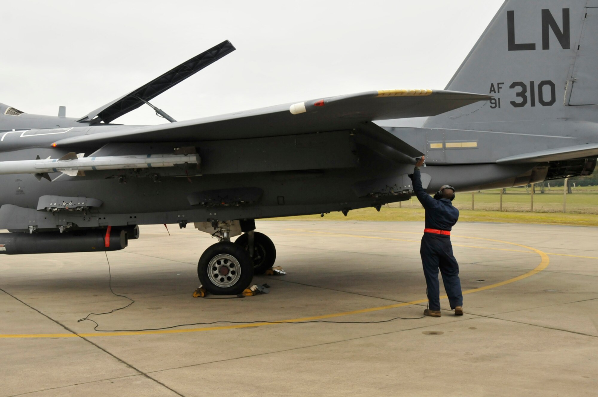 Airman 1st Class Andre Griffin, 48th Aircraft Maintenance Squadron F-15 crew chief, relays to Lt. Col. David Peterson, 494th Fighter Squadron pilot, that his flaps and air break are functioning properly, Feb. 11, 2009, at RAF Lakenheath, England. Before taking off for their sortie, F-15 Crew Chiefs help the aircrew perform pre-flight inspections to ensure the air craft is ready to fly. (U.S. Air Force photo by Airman 1st Class Perry Aston) 