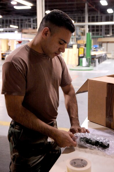 Senior Airman Lorenzo Guevara, 4th Fighter Wing Traffic Management Office, bubble wraps radioactive devices to protect them from being damaged if shipments are dropped on Seymour Johnson Air Force Base, N.C., Feb. 11, 2009. The 4th Logistic Readiness Squadron's mission is to the move the wing. (U.S. Air Force photo by Airman 1st Class Whitney Lambert)