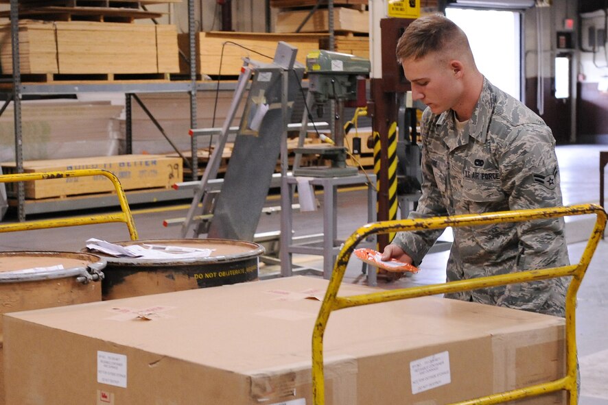 Airman 1st Class Edwin Gore, 4th Fighter Wing Traffic Management Office, checks information to ensure the box goes in the right combined shipment manifold on Seymour Johnson Air Force Base, N.C., Feb. 11, 2009. The 4th Logistic Readiness Squadron's mission is to the move the wing.  (U.S. Air Force photo by Airman 1st Class Whitney Lambert)